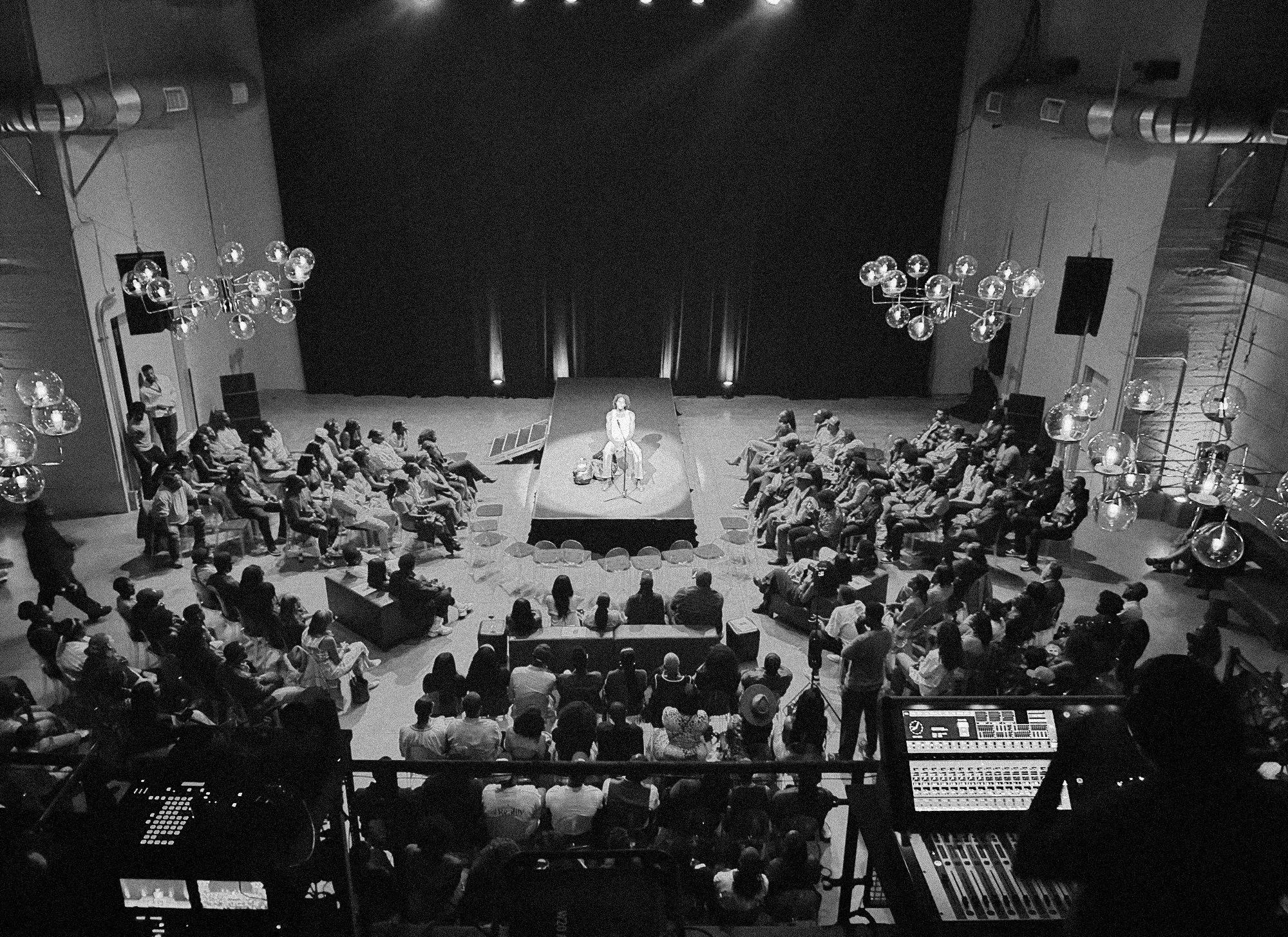 A black and white image of a top down view of a performance.