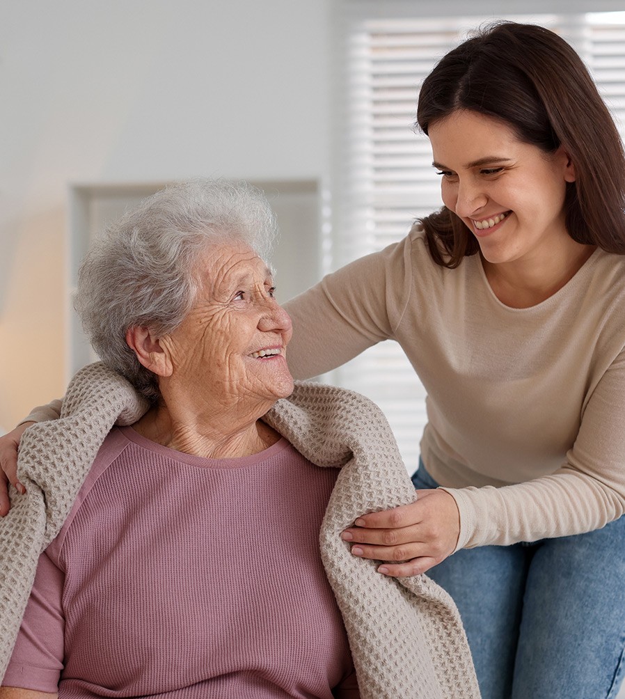 Caregiver helping a senior with breakfast in her Twin Cities home