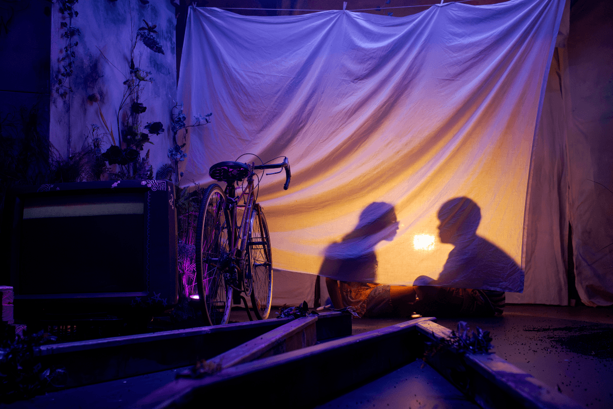 Shadows of two kids behind a sheet