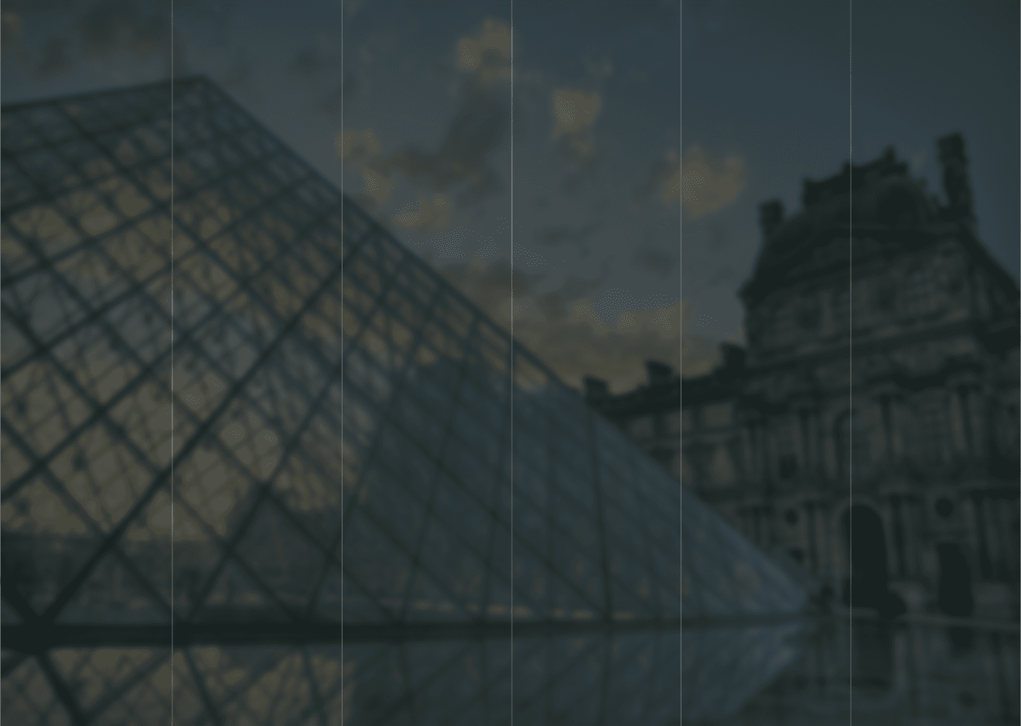 a glass pyramid in front of Louvre