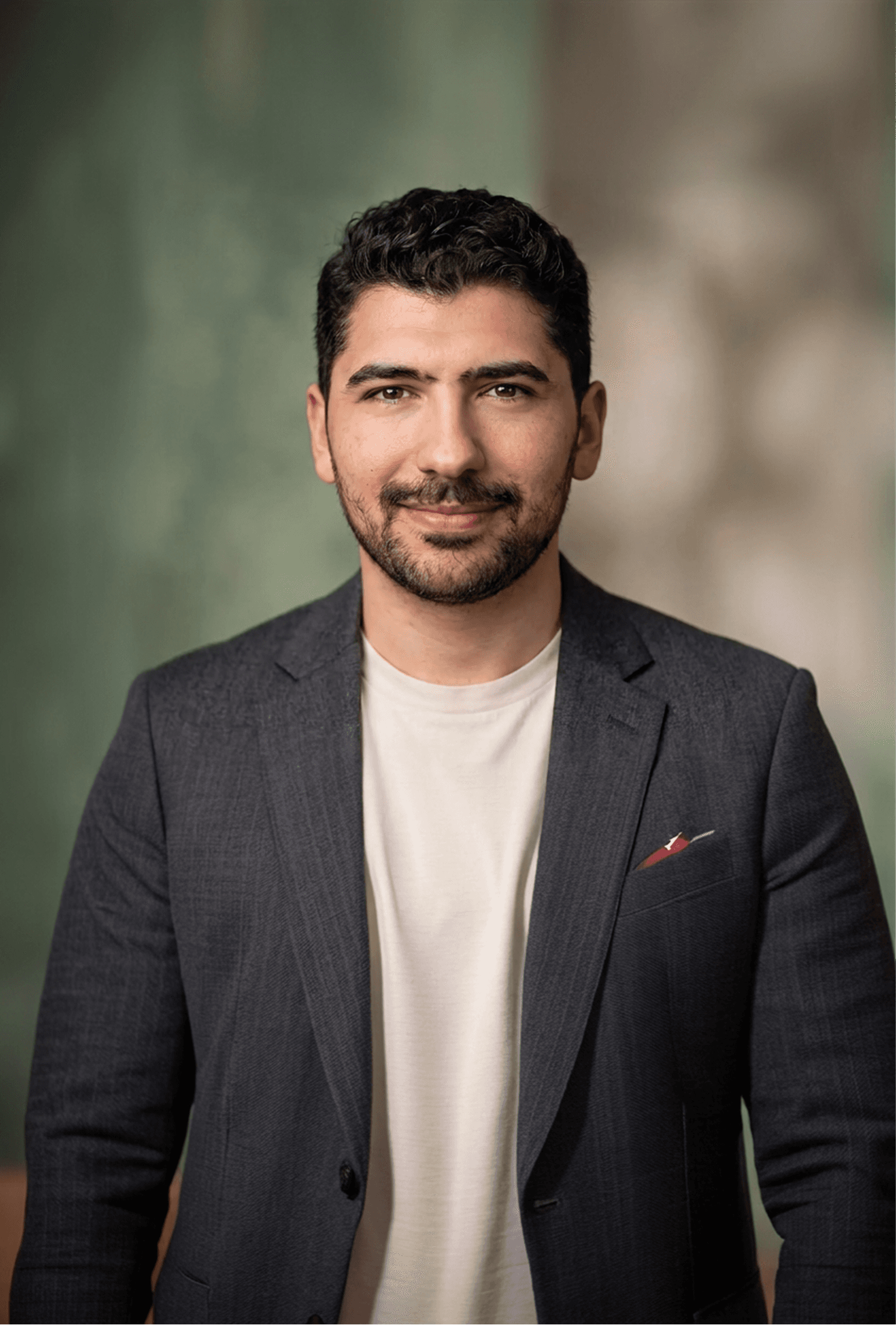 a man in a suit posing for a picture
