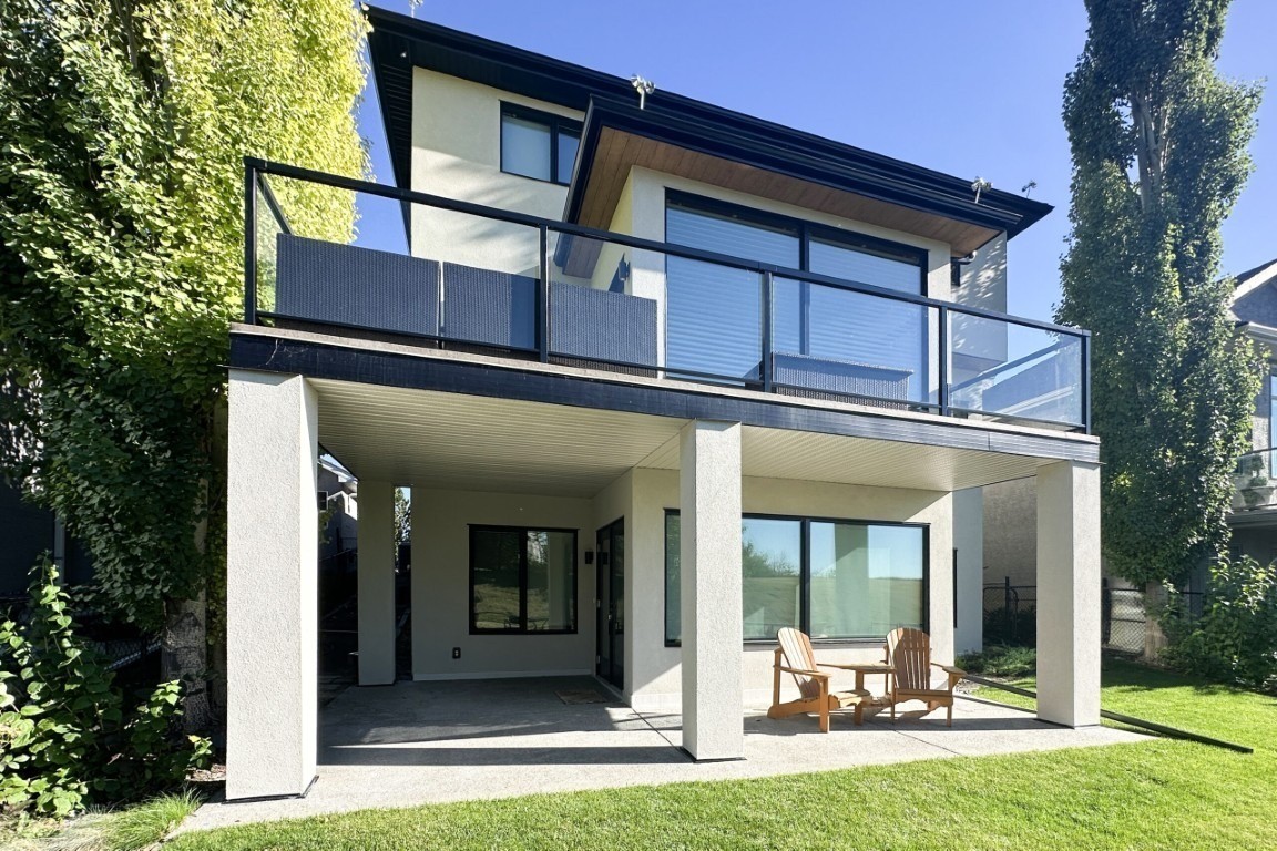 Image of Modern two-story home design with balcony and patio by KHD Homes, showcasing expert home builder work.