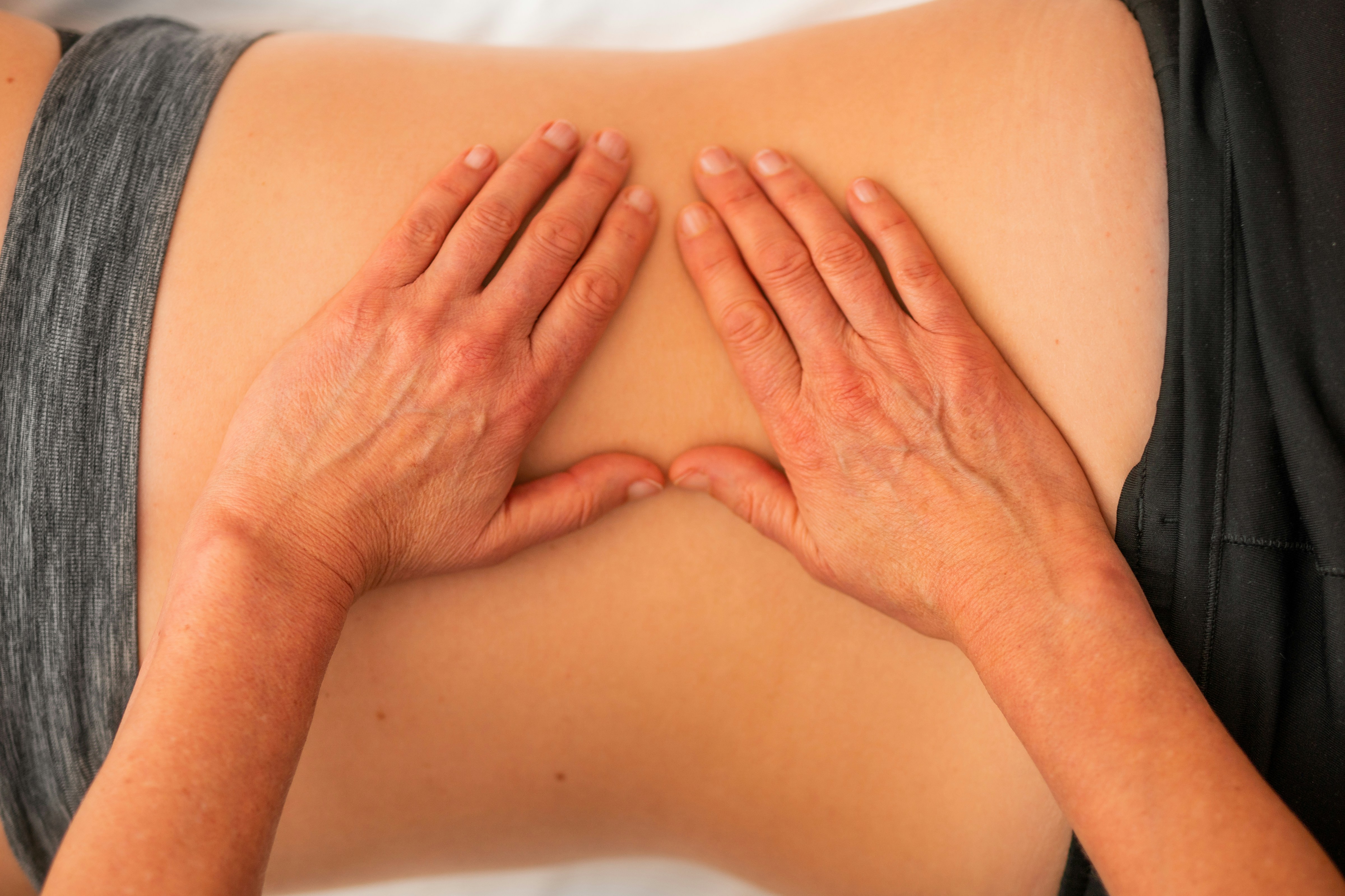 physiotherapist handling a patient's back