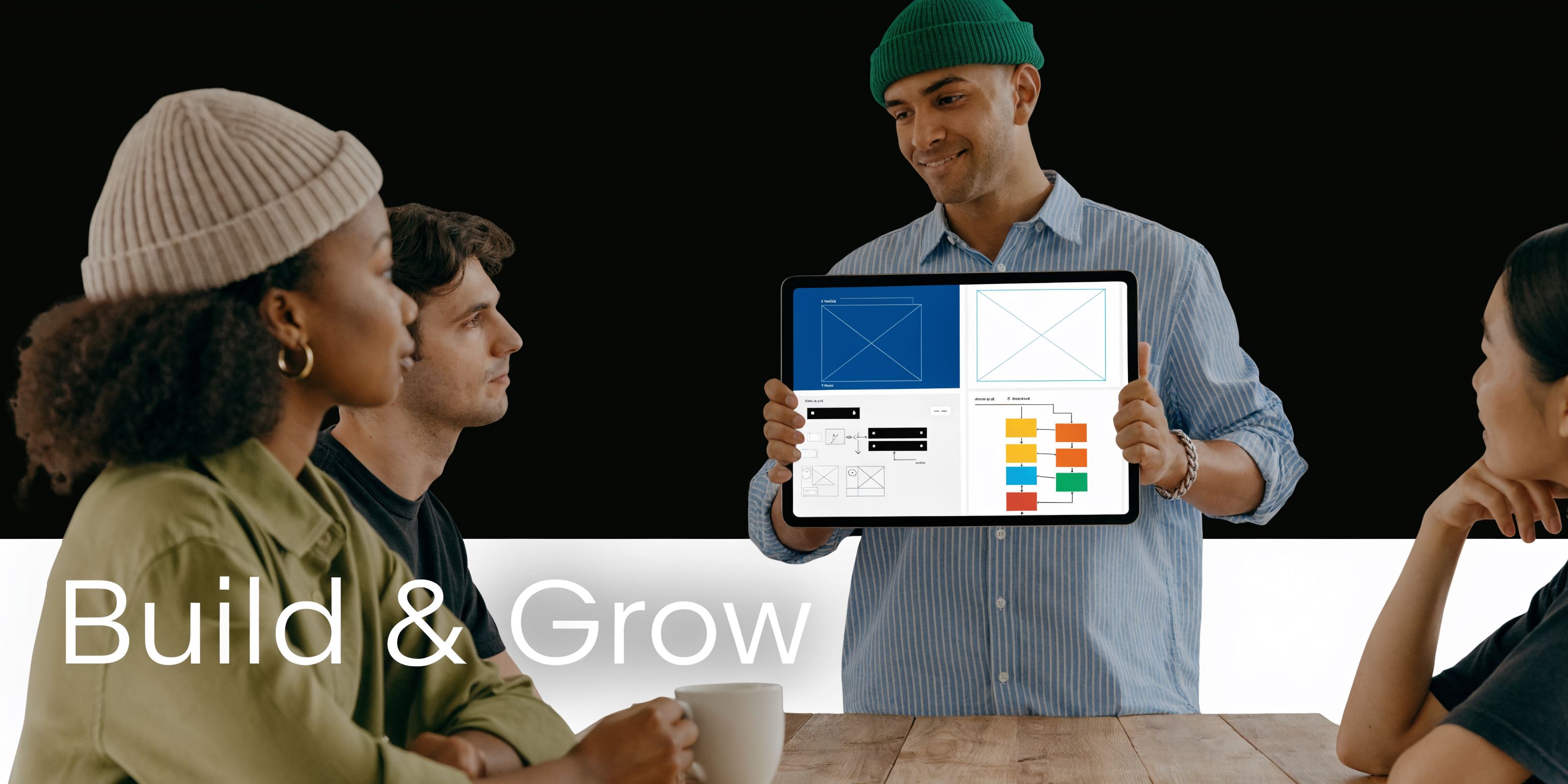 A professional team collaborating on software design using visual programming environments on a digital tablet in an office.