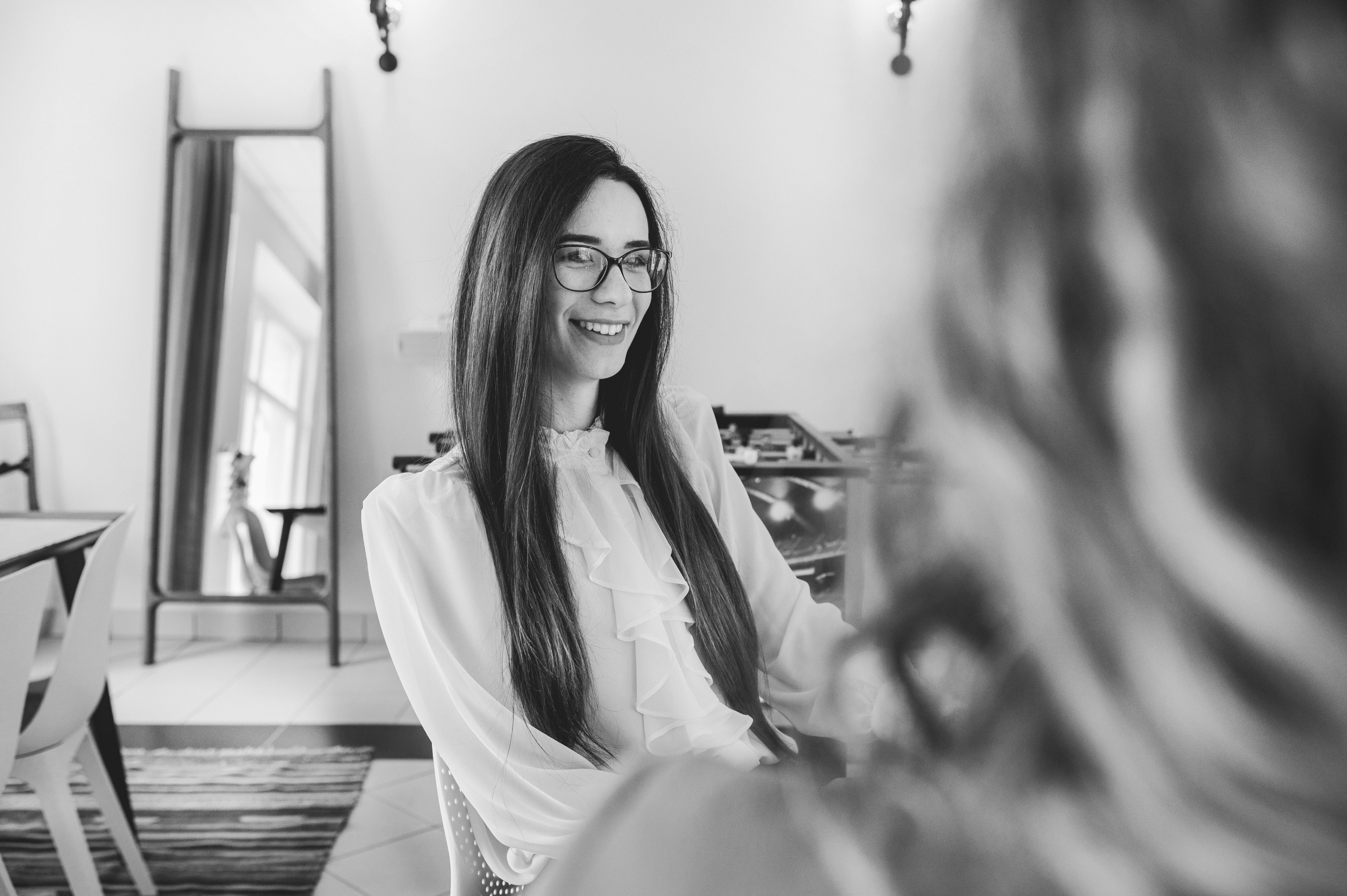 A woman on a break chatting with a colleague, possibly discussing a quick meeting.