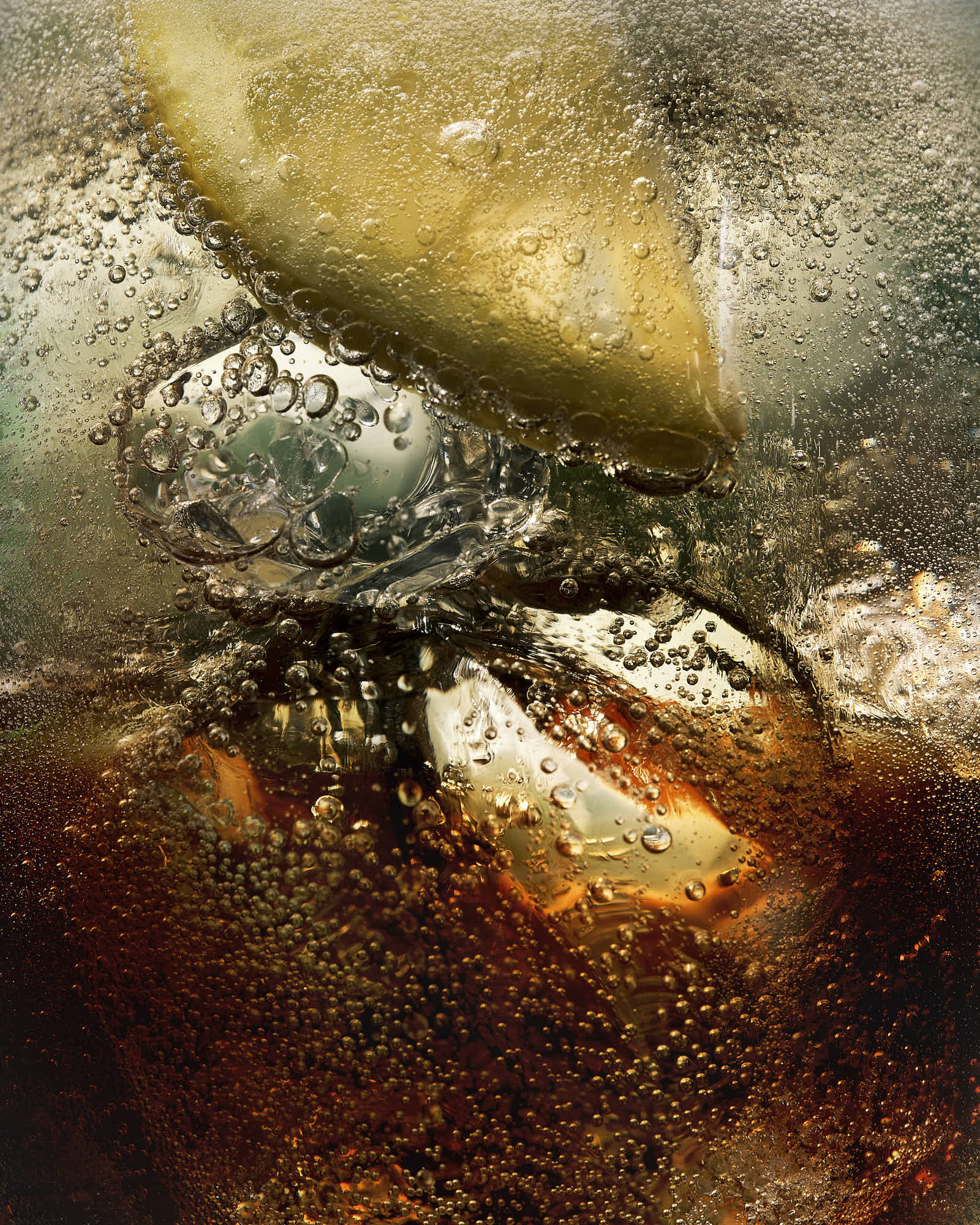 Close-up of a ombre cocktail with lemon wedge and colors blending together. With bubblyenergy 