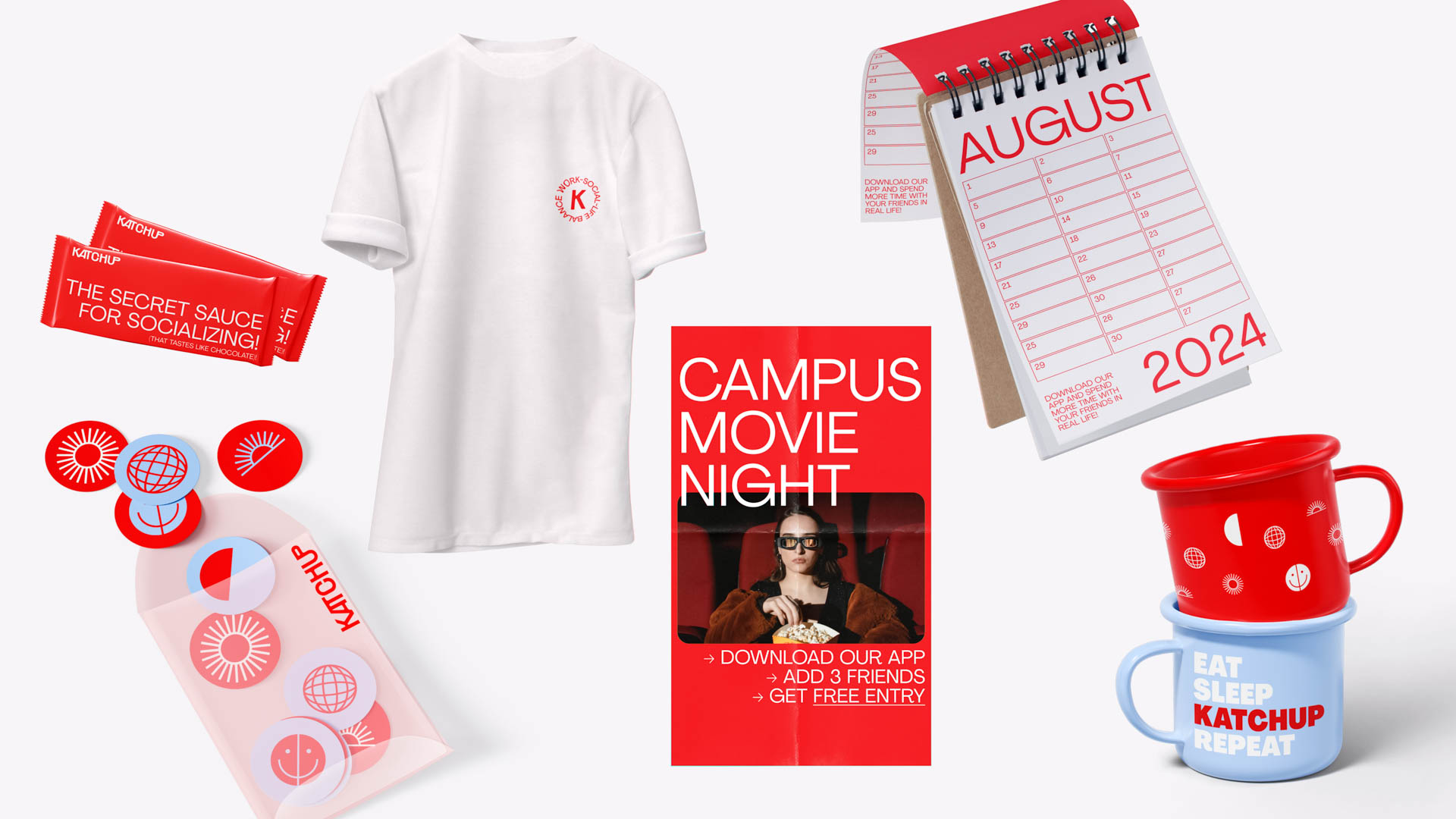 A white t-shirt with a small red logo is positioned on the left side. To its right is a red spiral-bound planner displaying the month of August and the year "2024." Below the planner is a red book titled "CAMPUS MOVIE NIGHT," featuring a woman in a brown jacket. On the left, a pink envelope with stickers and a red and white striped mug are visible. To the right, a red mug with white designs and a blue mug with white designs are placed together.