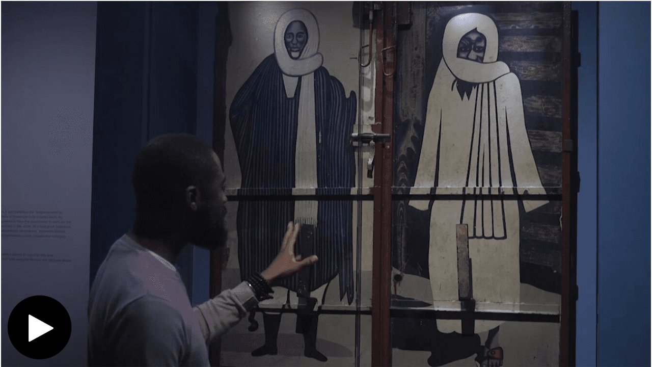 Youssef Carter talking and referencing to the restaurant doors Sheikh Amadou Bamba and Sheikh Ibra Fall.