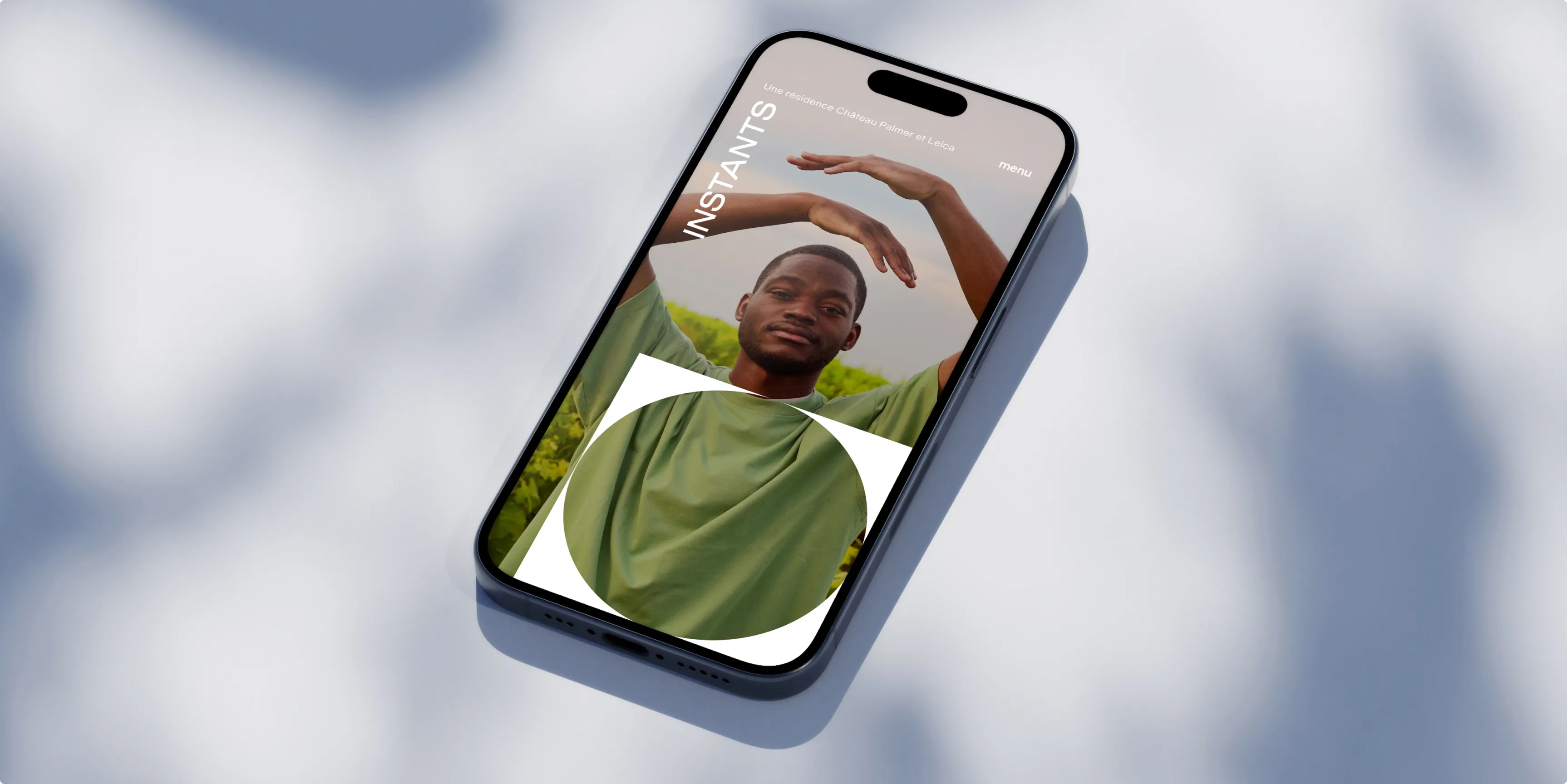 A smartphone lying on a surface, displaying a person's photo with a green background.