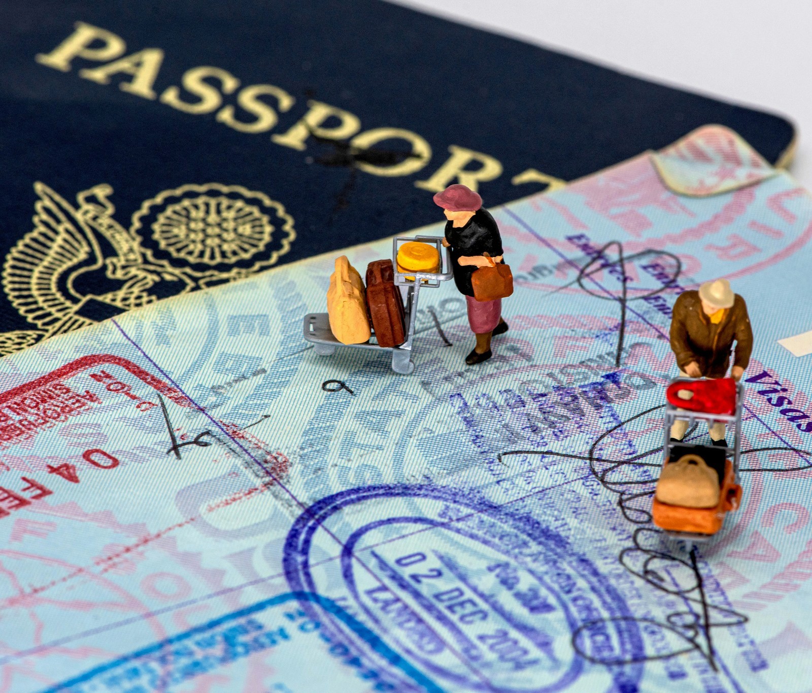 2 men in yellow and black suit action figures, on an article about the 10-year China visa for U.S. citizens