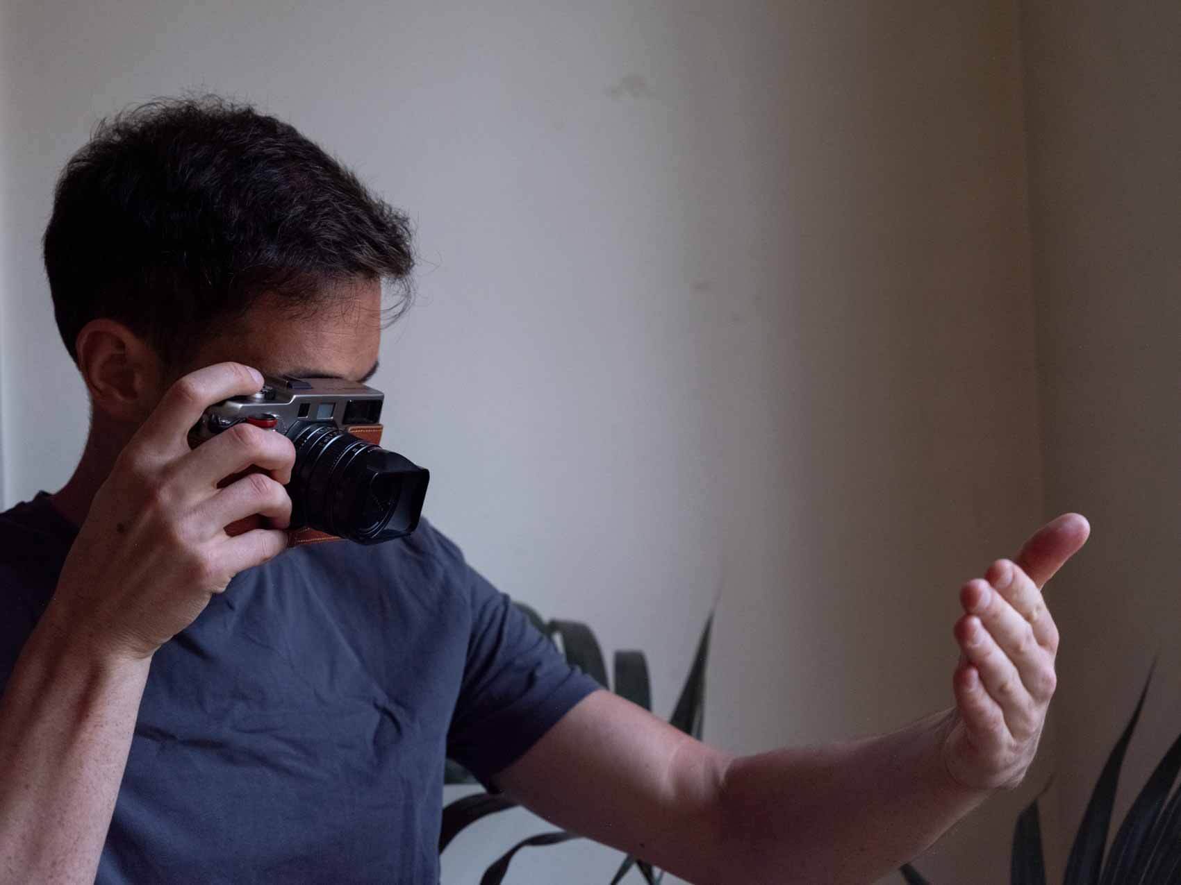 Photographer measuring light from their hand for a light meter reading