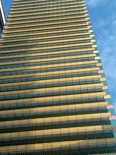 A photo of the side of a modern multistory building with panels.