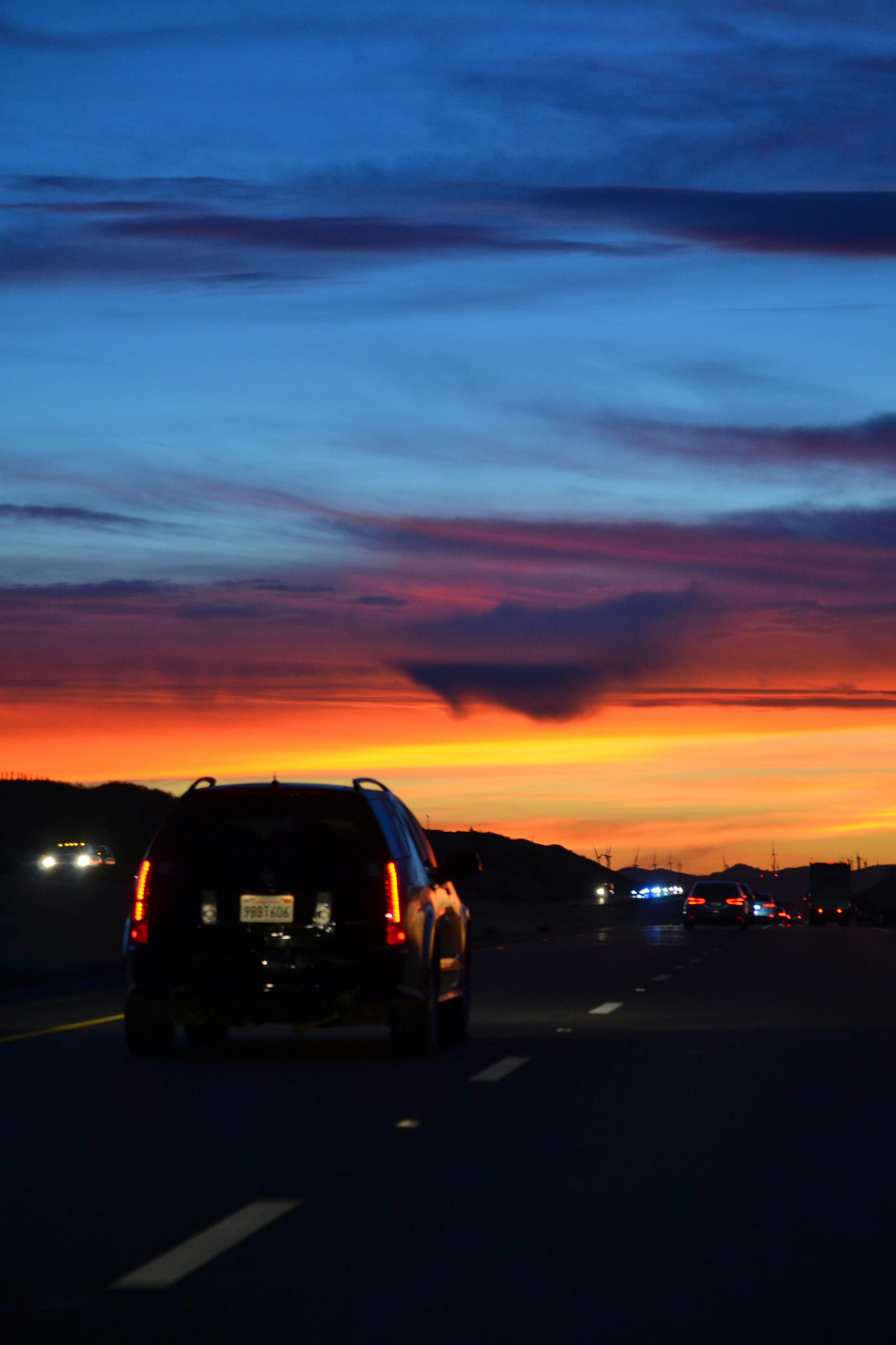 a car driving down a highway at sunset