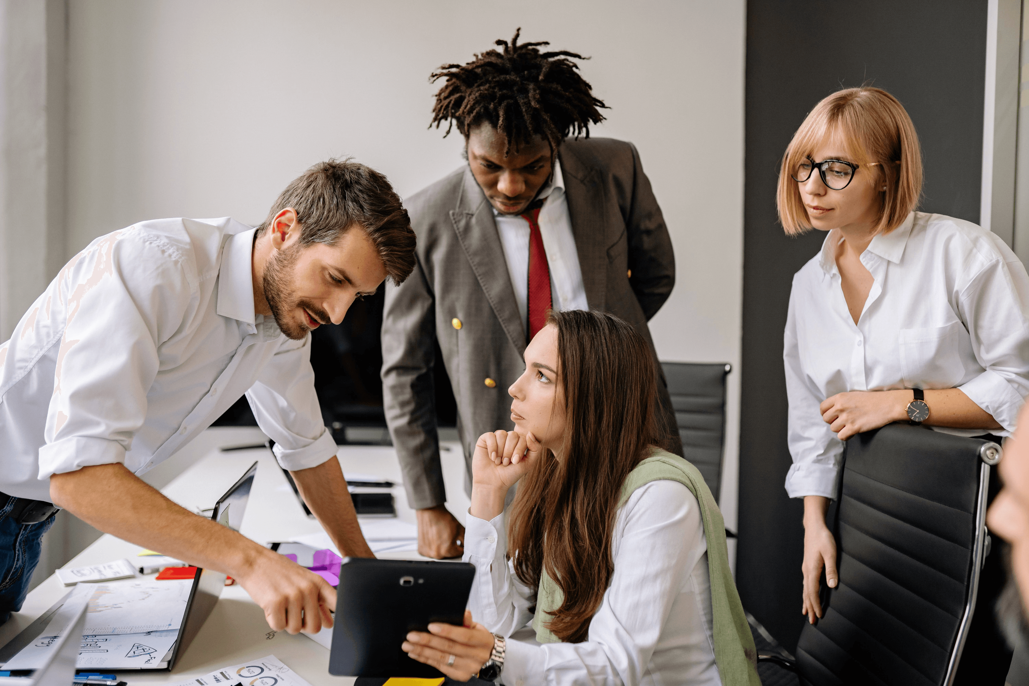 Team reviewing work on a tablet