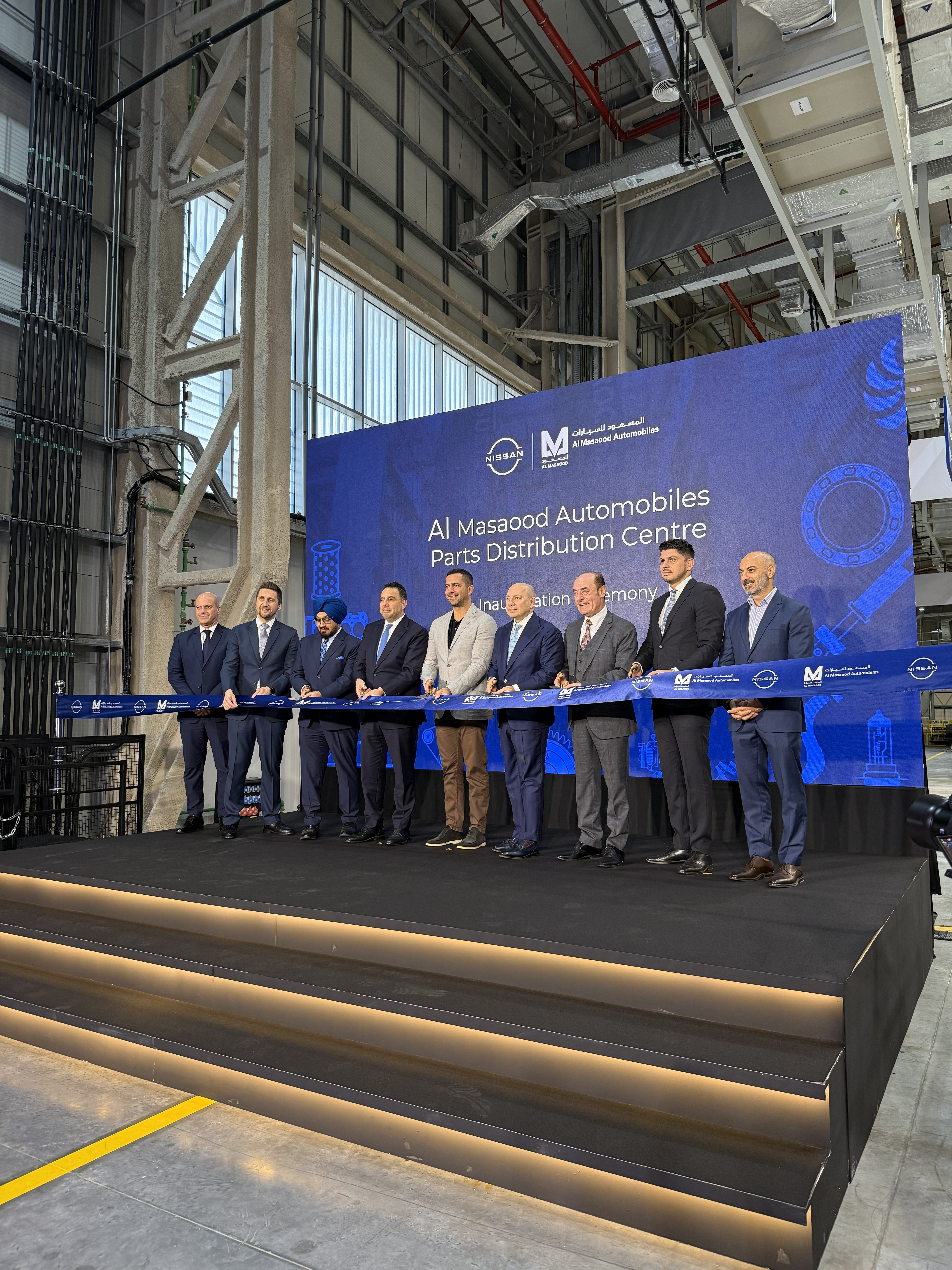 Female scientist wearing a white coat and gloves examines a sample slide in a modern laboratory setting.
