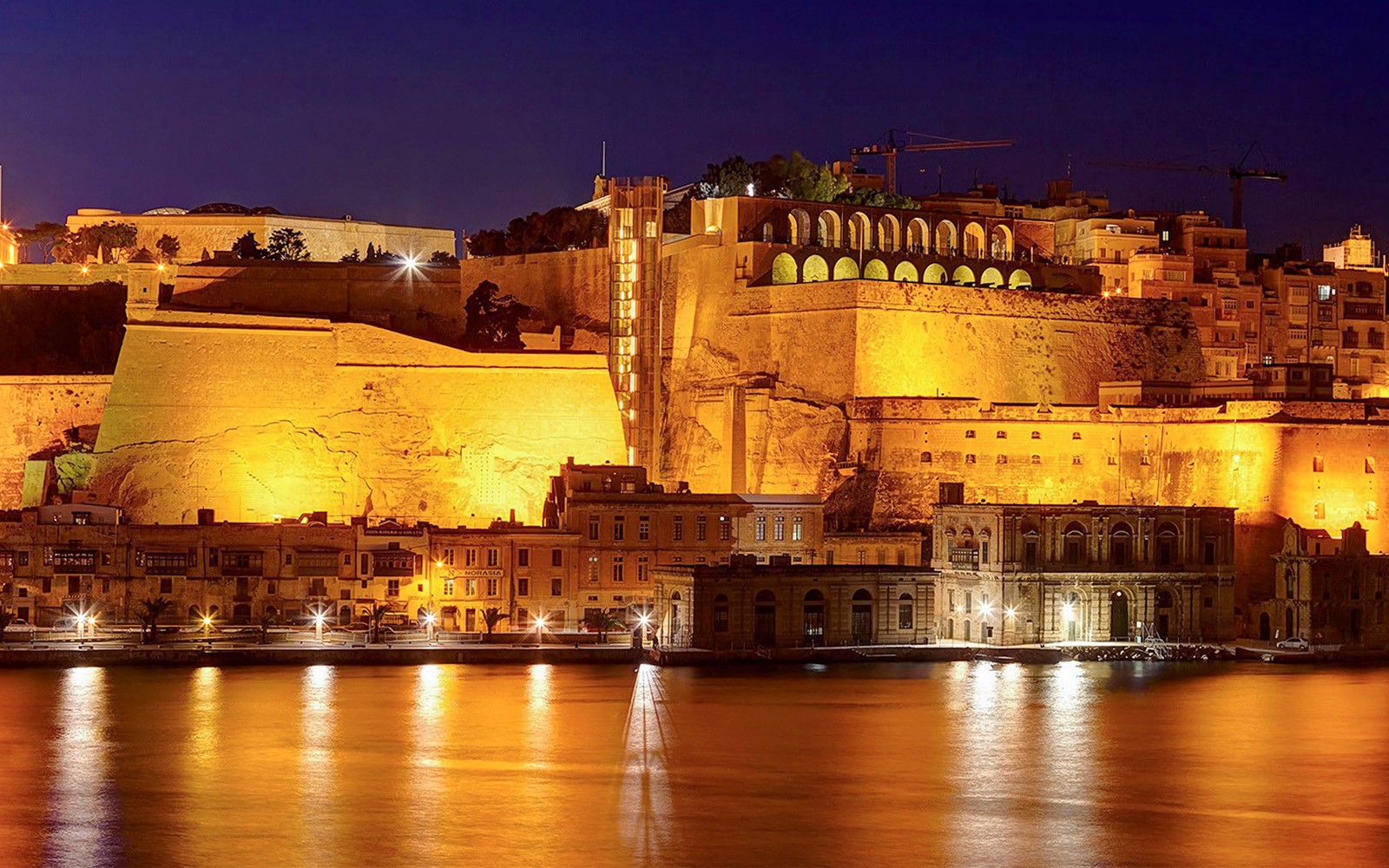 Valletta cityscape illuminated at night during a 3-hour guided tour in Malta.