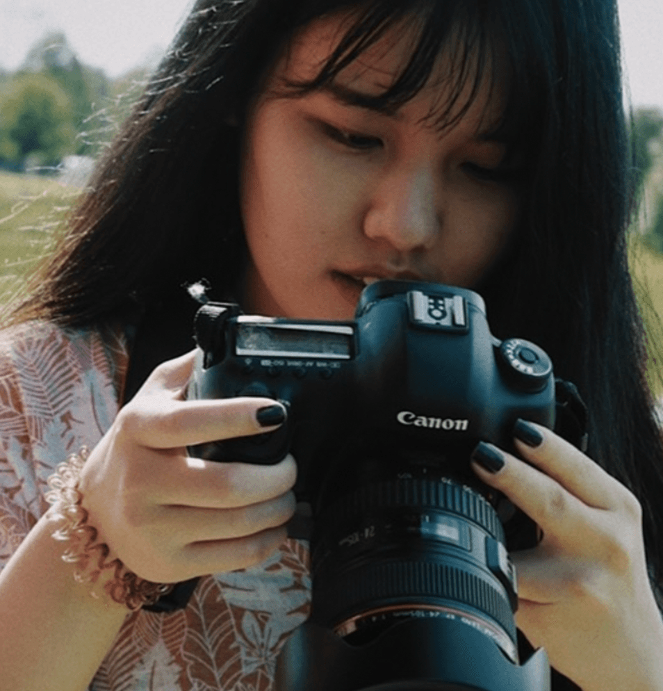 asian woman holding camera in the nature