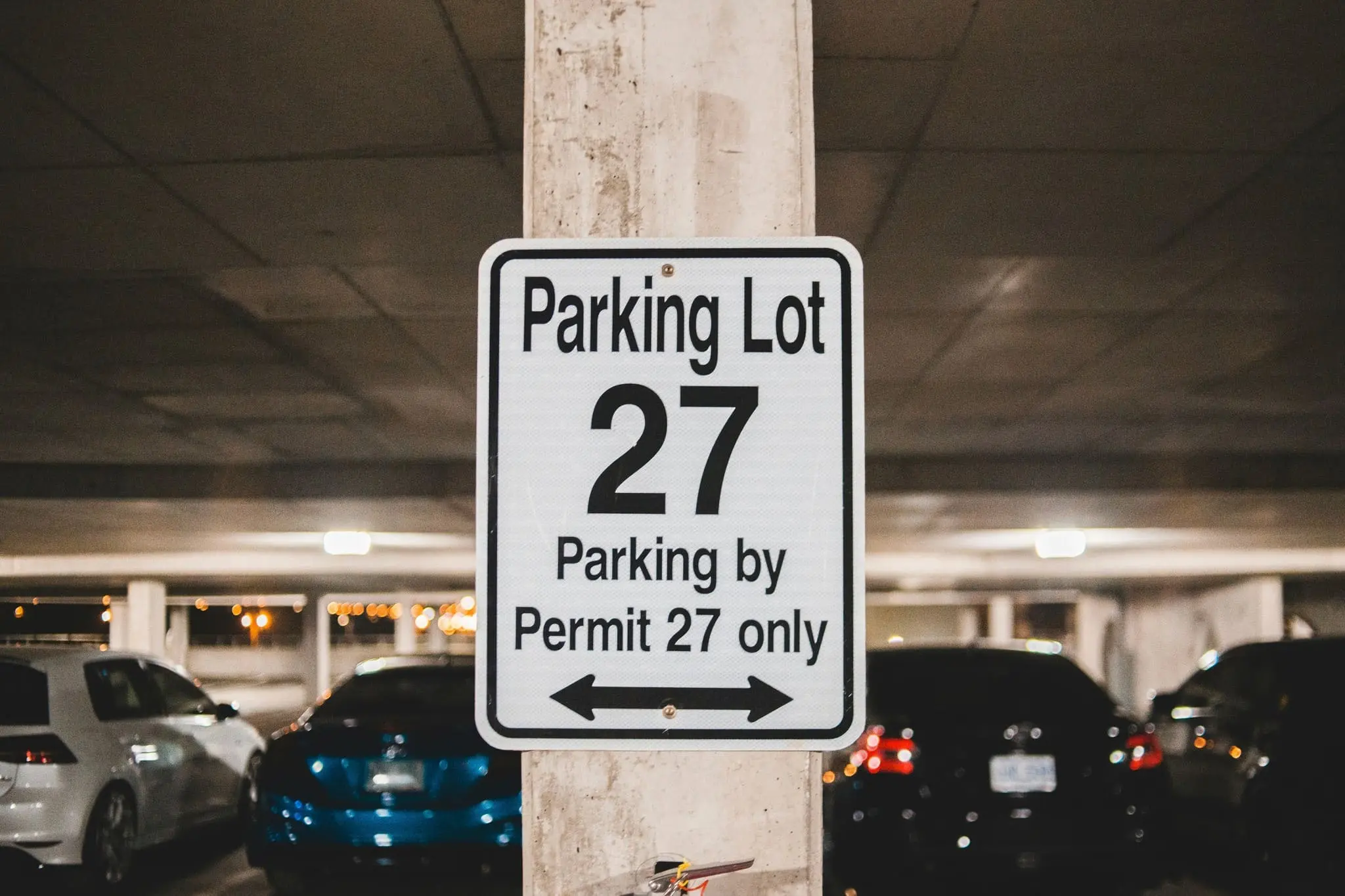  Sign in a parking garage indicating Parking Lot 27 is permit-only.