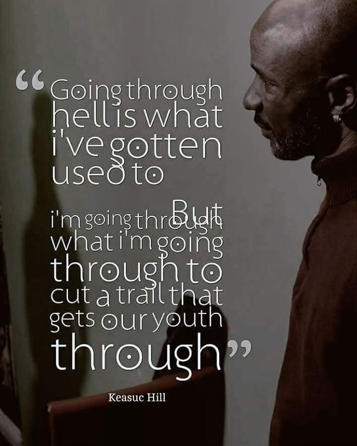 Woman practicing yoga in tree pose on a wooden deck overlooking misty mountain landscape at sunrise.