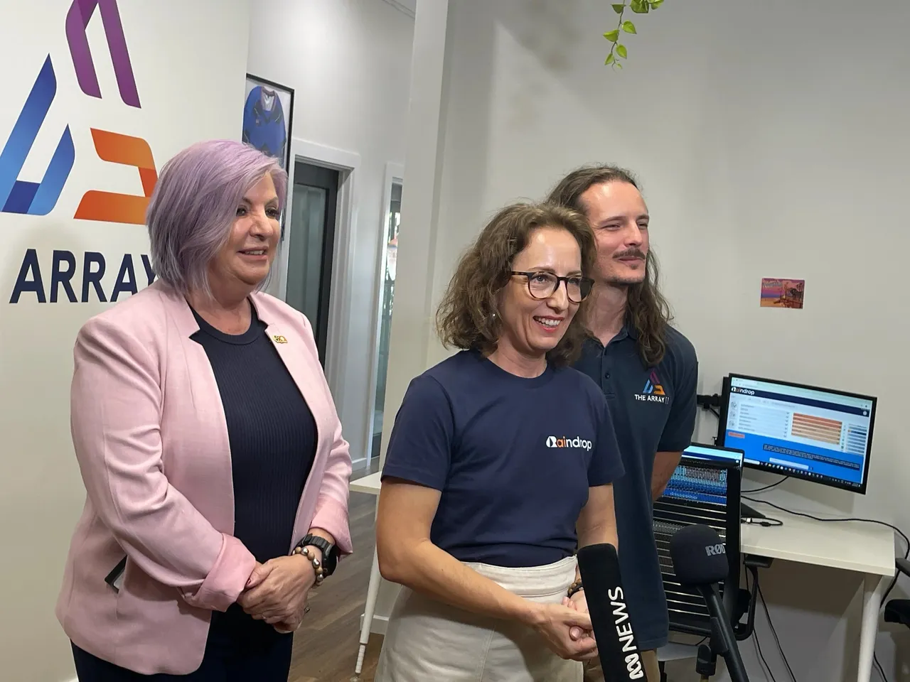 Jasmin Flori-Hess answers question of journalists amongst press conference with Minister Robyn Cahill and Dylan Bennett of The Array