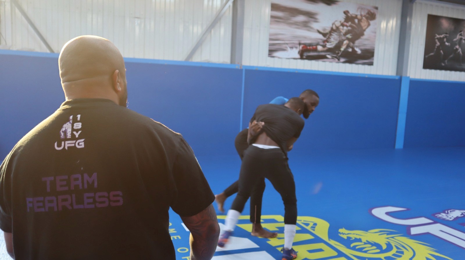 Athletes drilling takedowns in a wrestling class at Fearless MMA