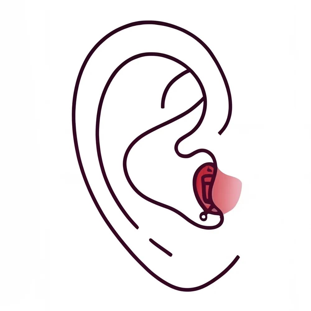 Close-up of a human ear, with wavy hair partially covering it, focusing on the ear's shape and contours.