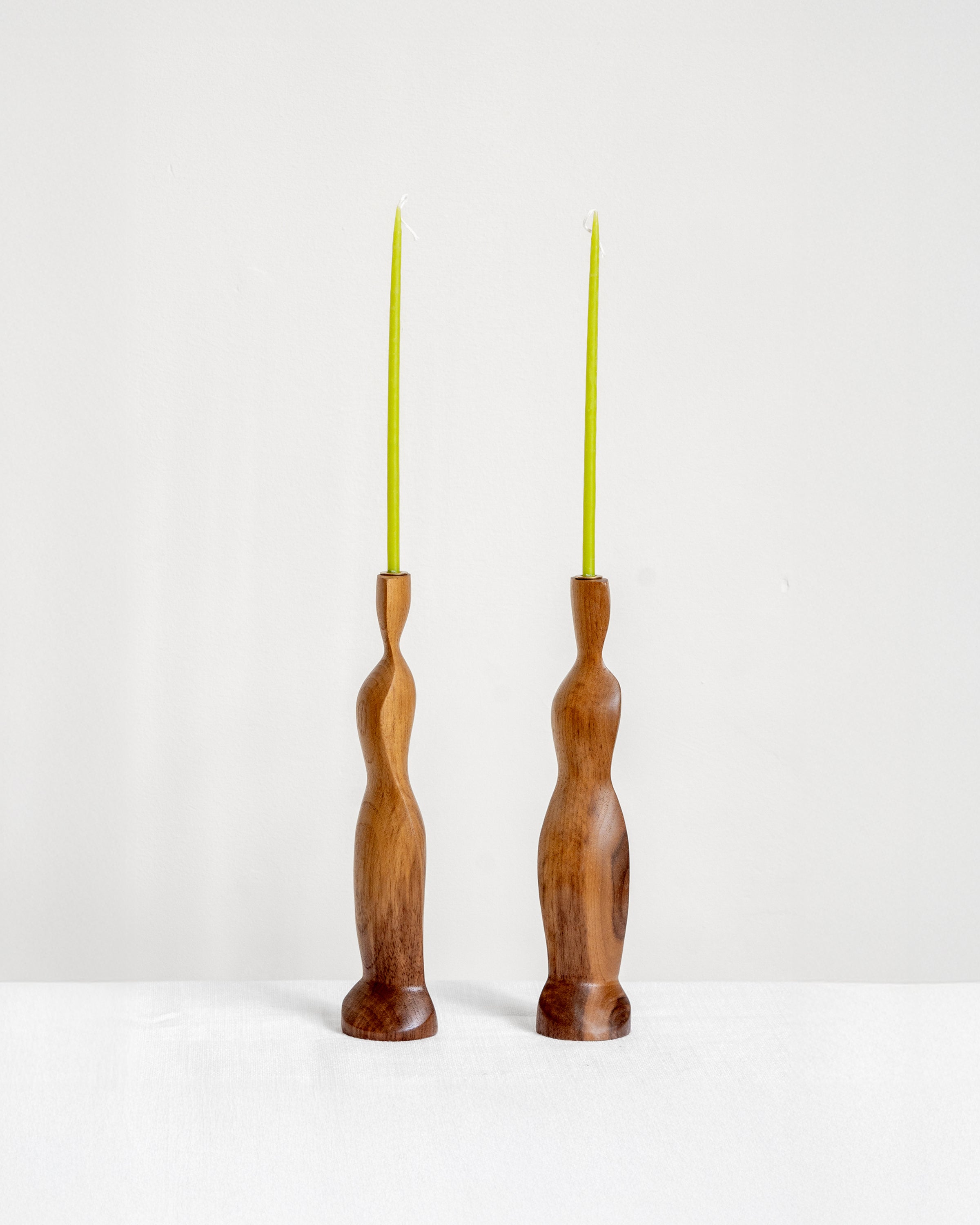 Figura Candlestick holders in Walnut on white background with green candles