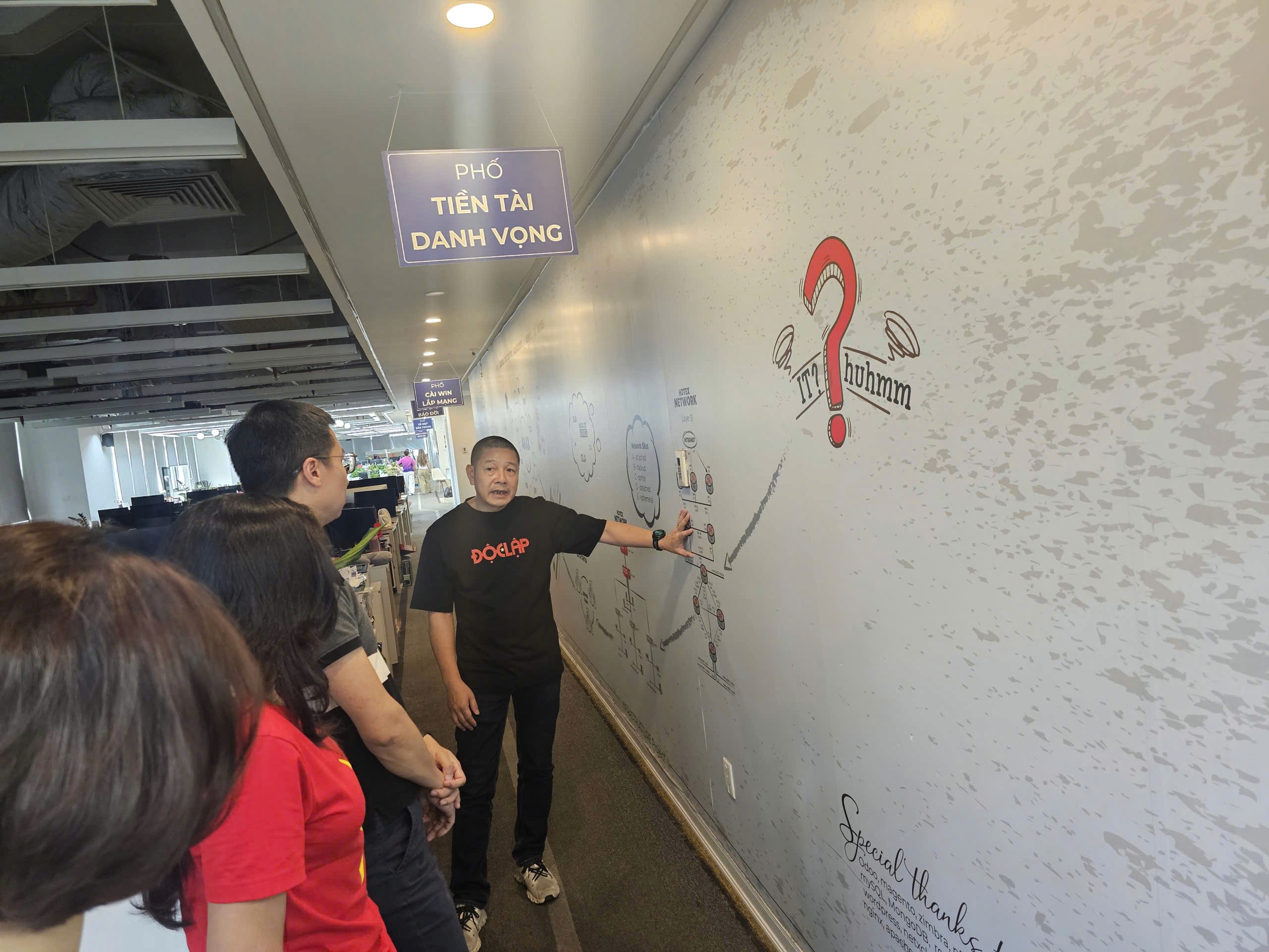 people sitting down near table with assorted laptop computers