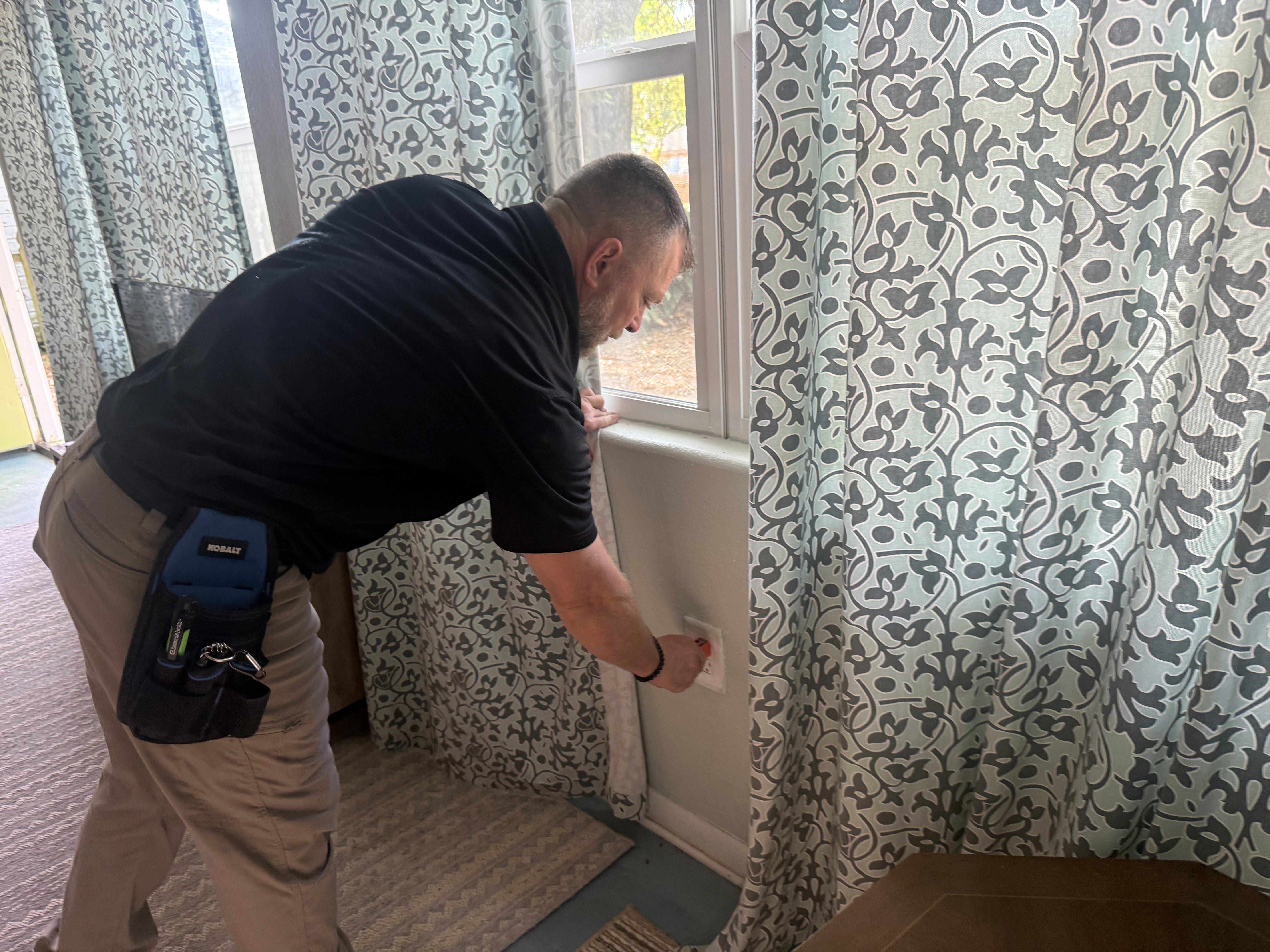 Home inspector in Louisiana with inspection sign outside residential property