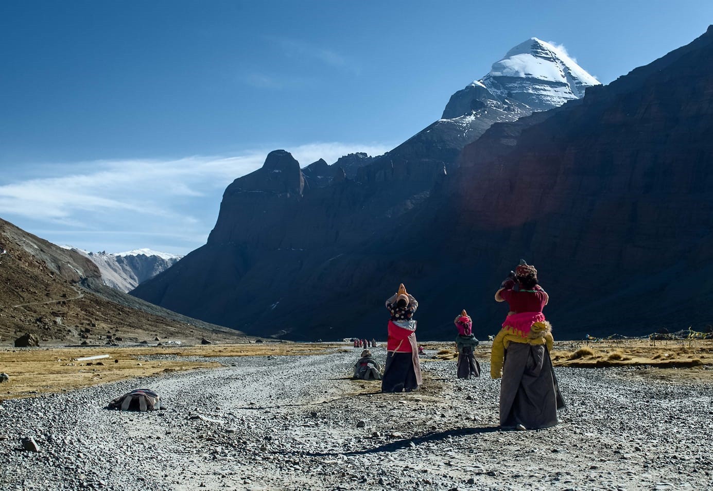 two women in purple and pink kimono standing on street