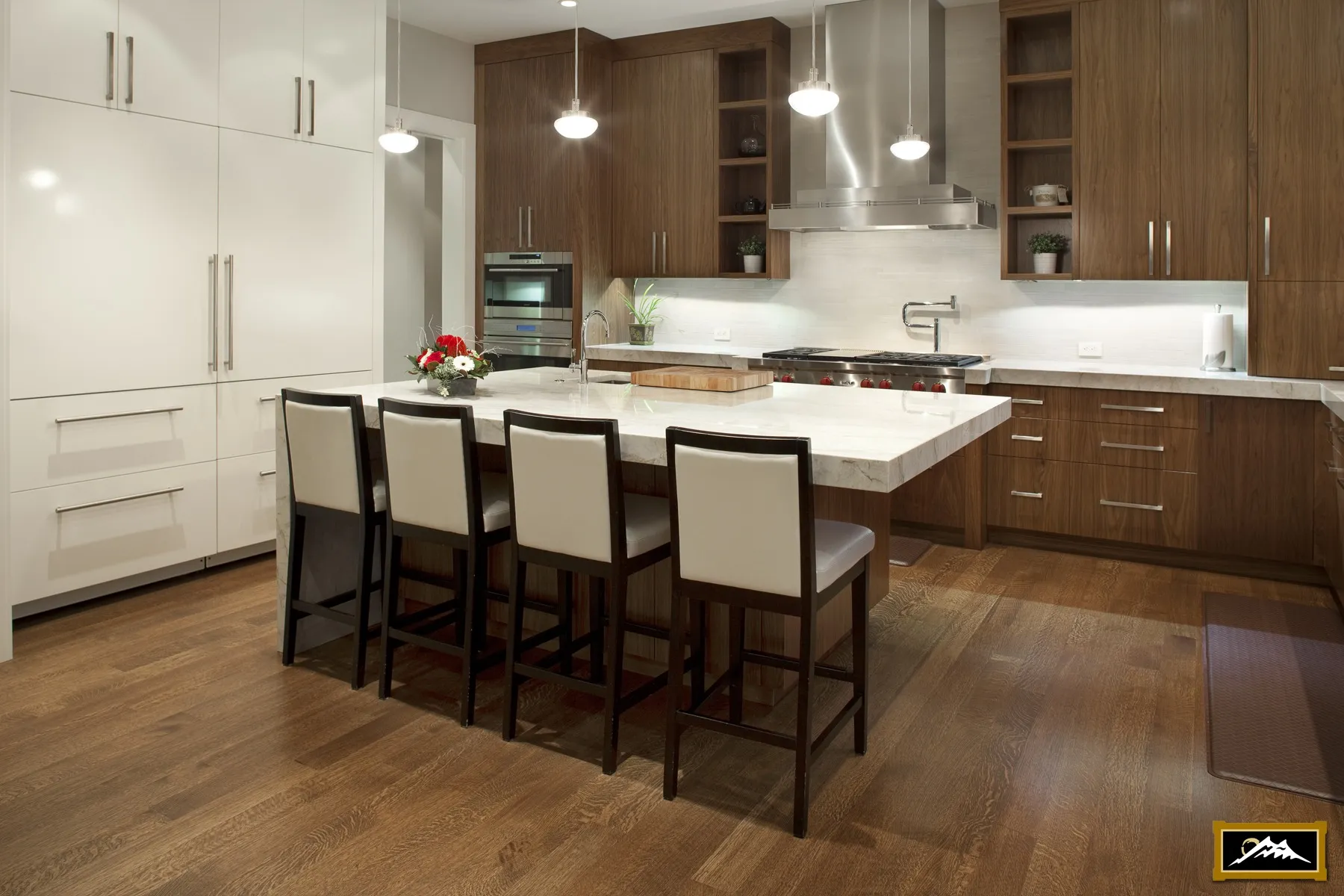 Image of large kitchen with mid-toned millwork.