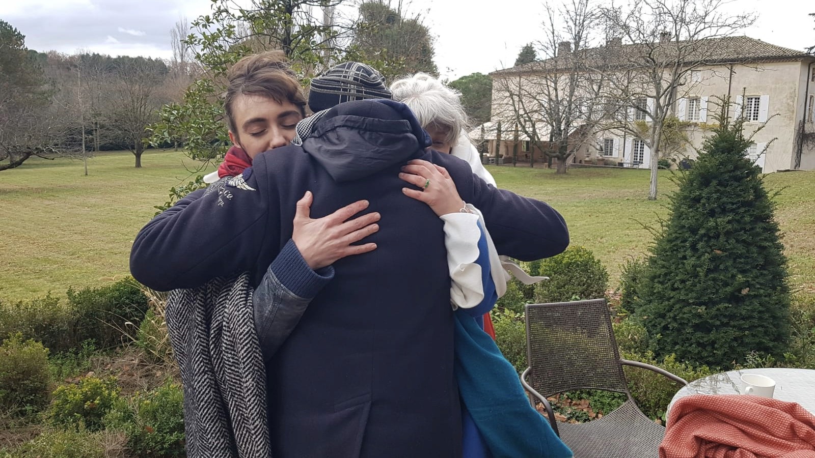Woman in pink leather jacket crouching outdoors at night
