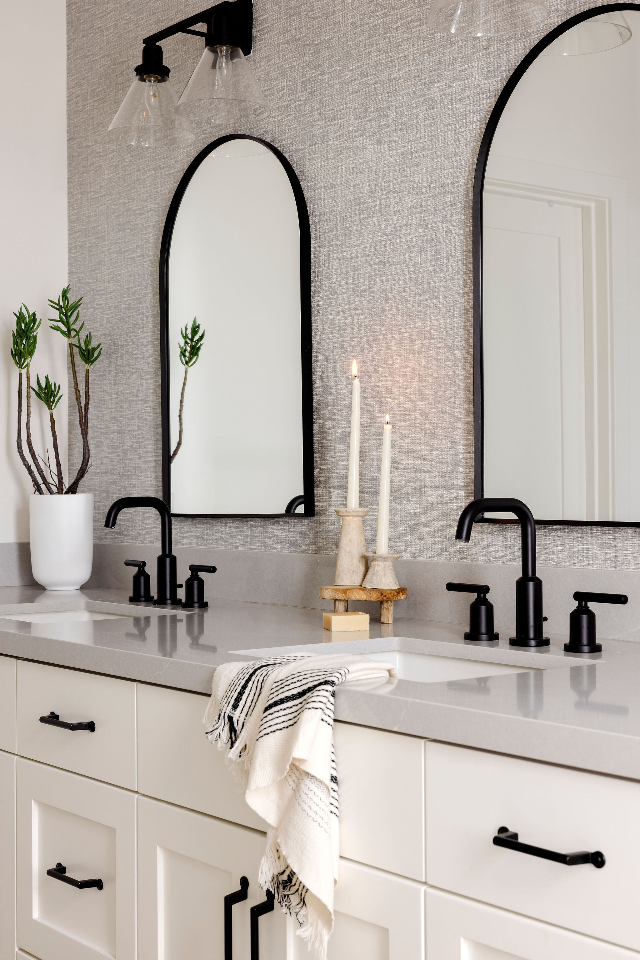 Luxe spa-like bathroom with a his and her sinks, soft lighting, and organic details.