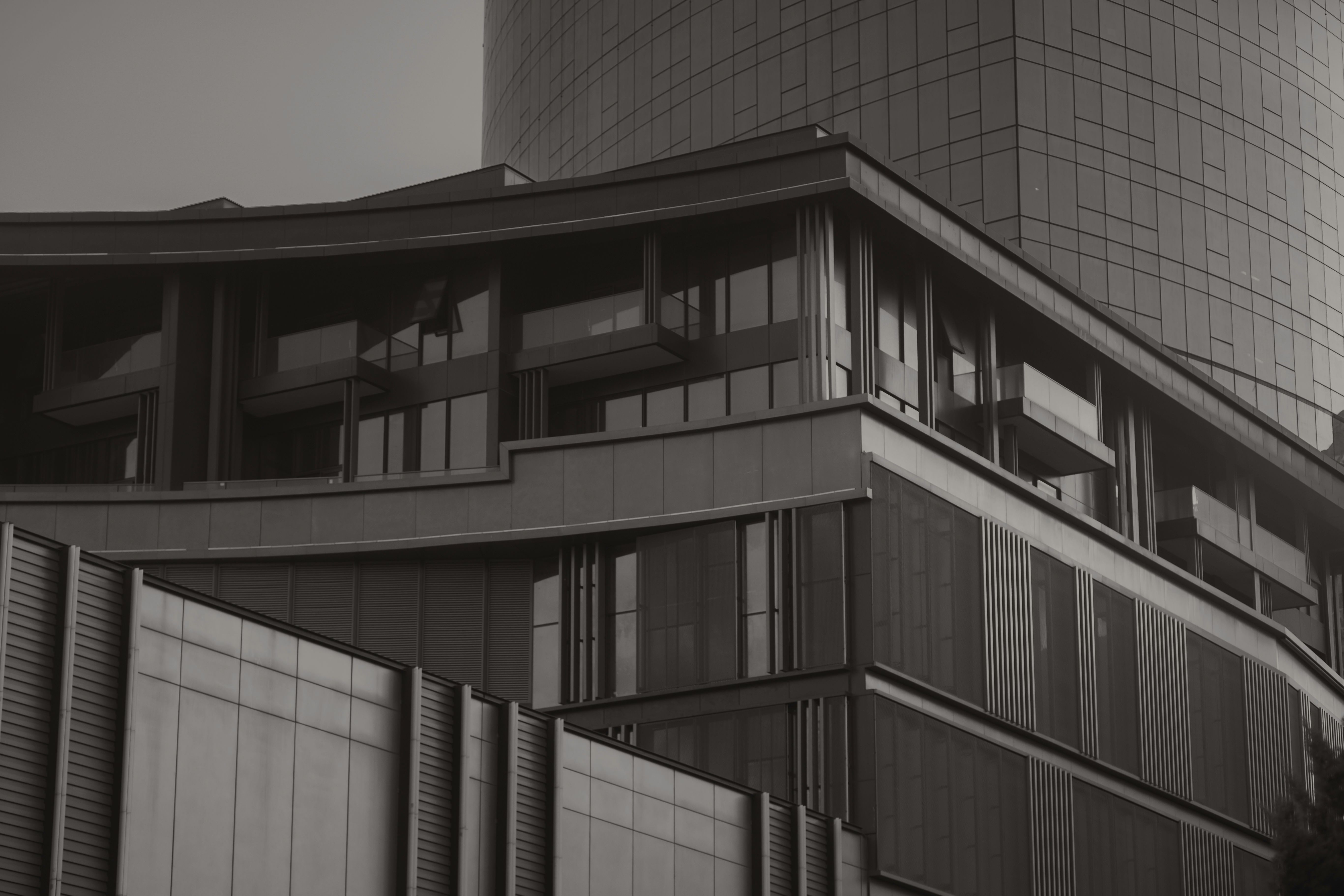 black-and-white-image-of-a-contemporary-building-with-glass-facade-and-sleek-des - rahib-hamidov (pexels)