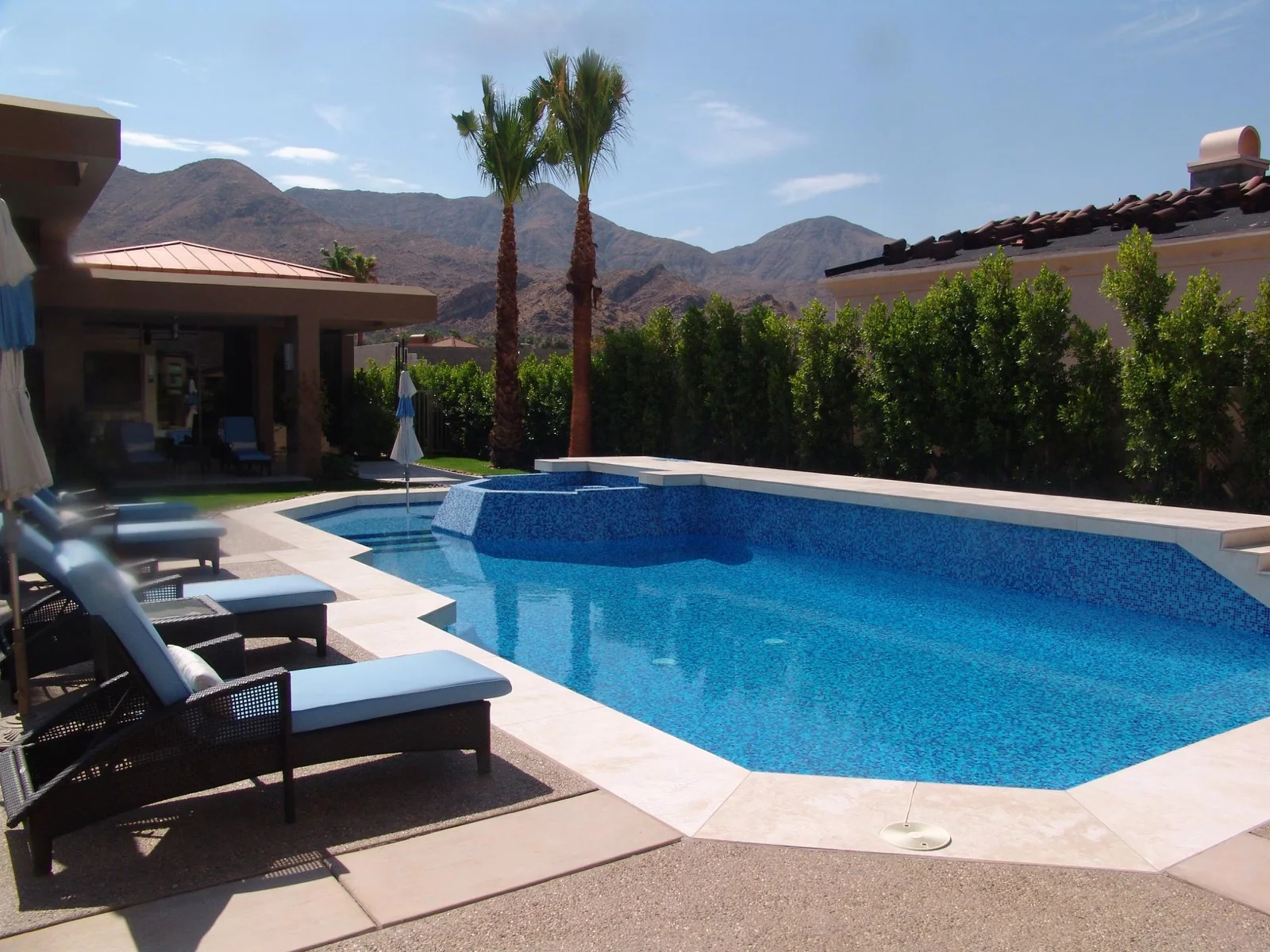 All-tile glass mosaic pool in Palm Springs, the whole interior in a blue hand-cut blend, with the desert mountains behind