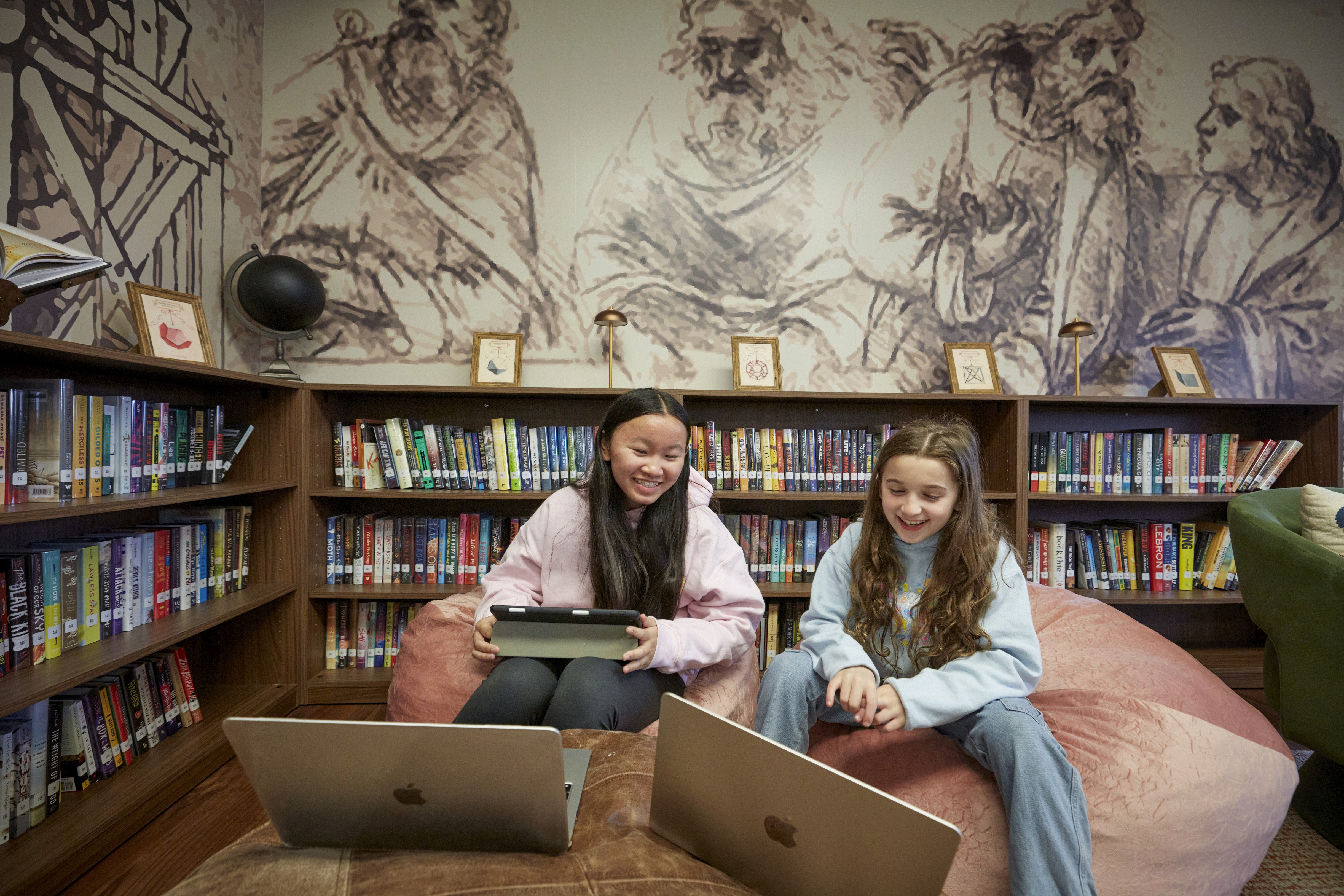 An interior shot from behind the driver, showing a man wearing sunglasses and a baseball cap driving a Jeep. His hands are firmly gripping the wheel. The car is on a road surrounded by green trees and fields visible through the windshield, under bright natural light.