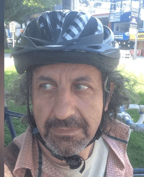 Profile portrait of a man in a grey shirt