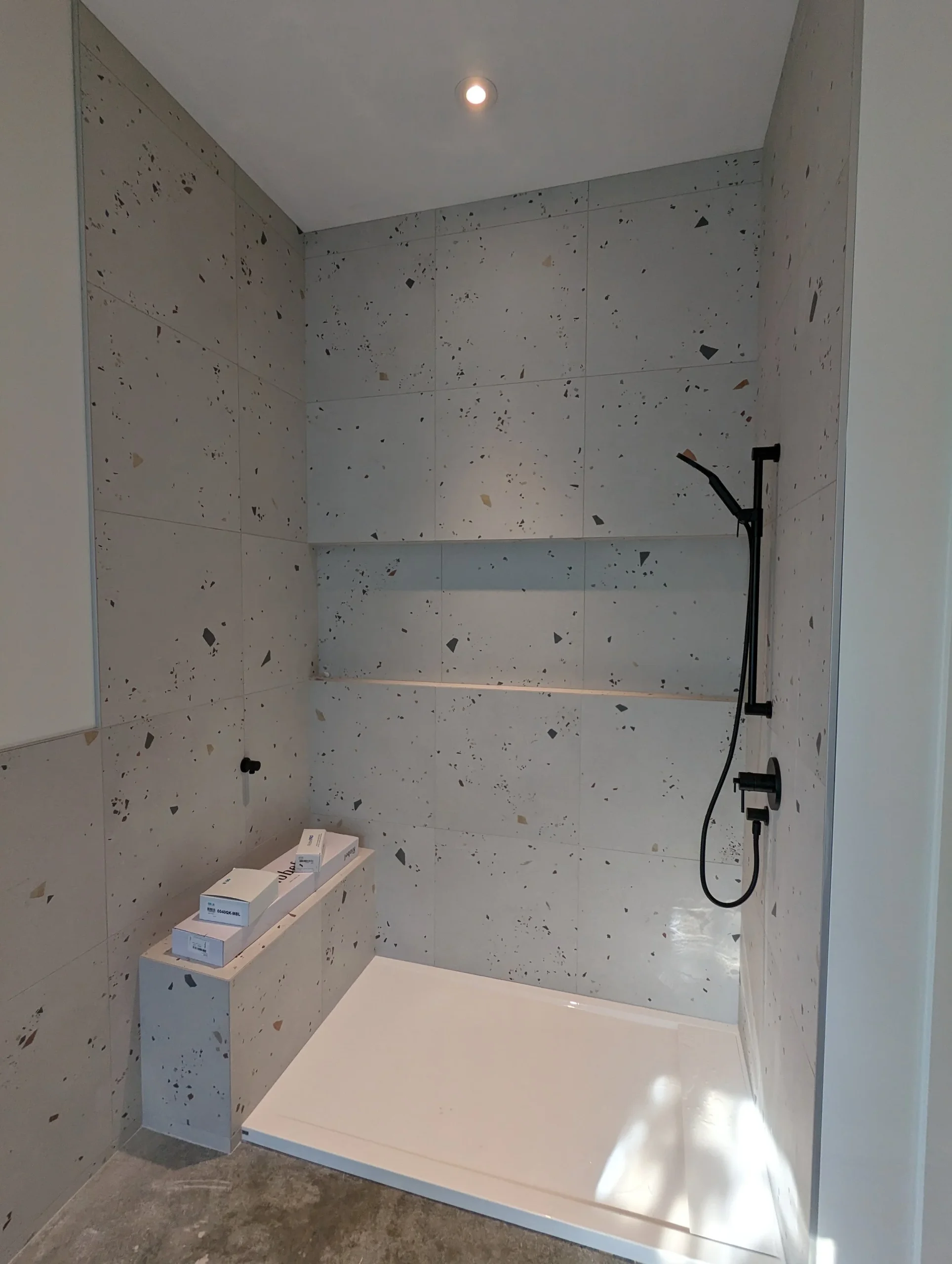 Modern two-story home with large glass windows, warmly lit interiors, and a balcony. Surrounded by trees and a manicured lawn at dusk. Cozy ambiance.