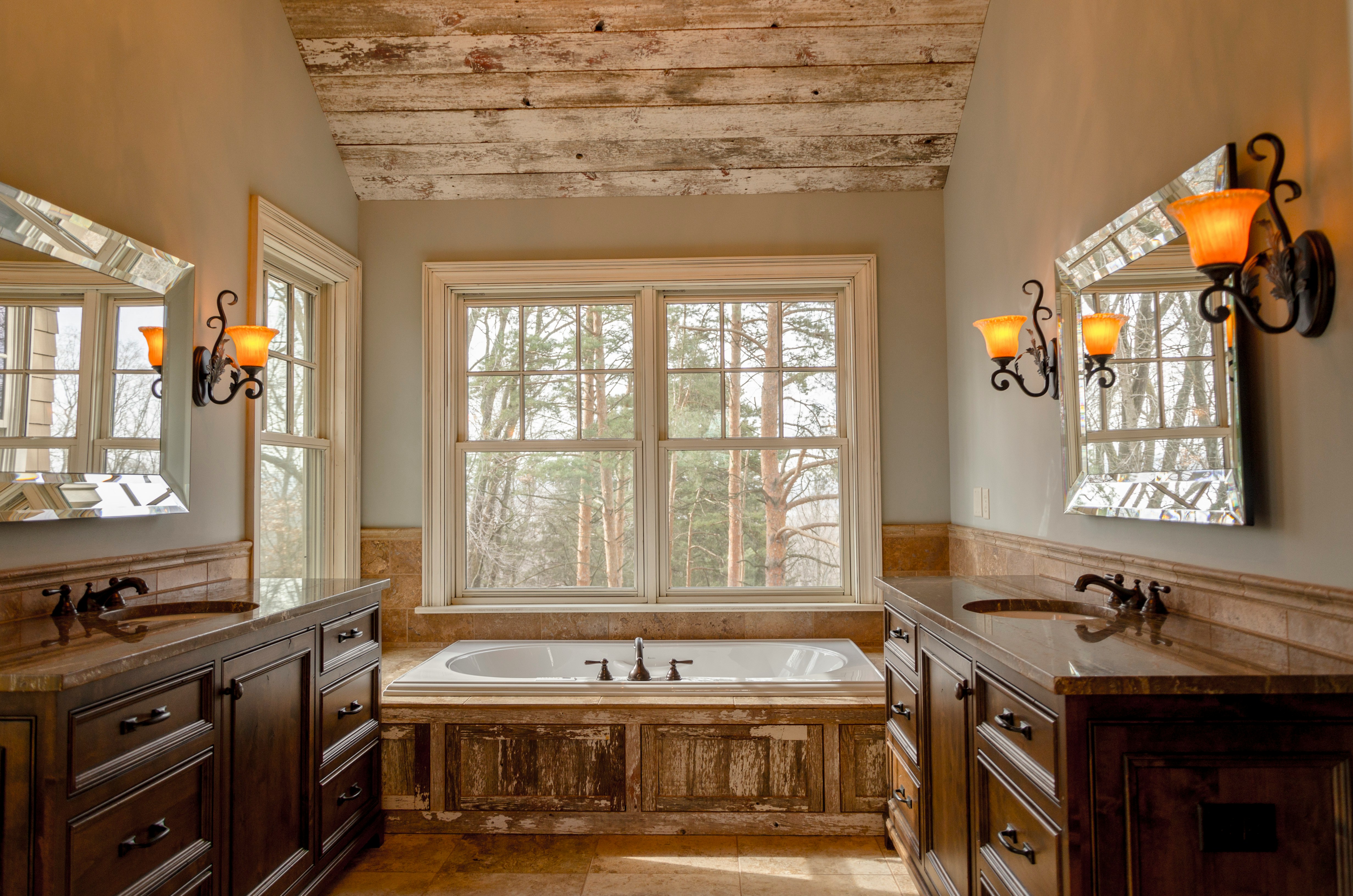 Rustic bathroom with a clawfoot bathtub and natural light.