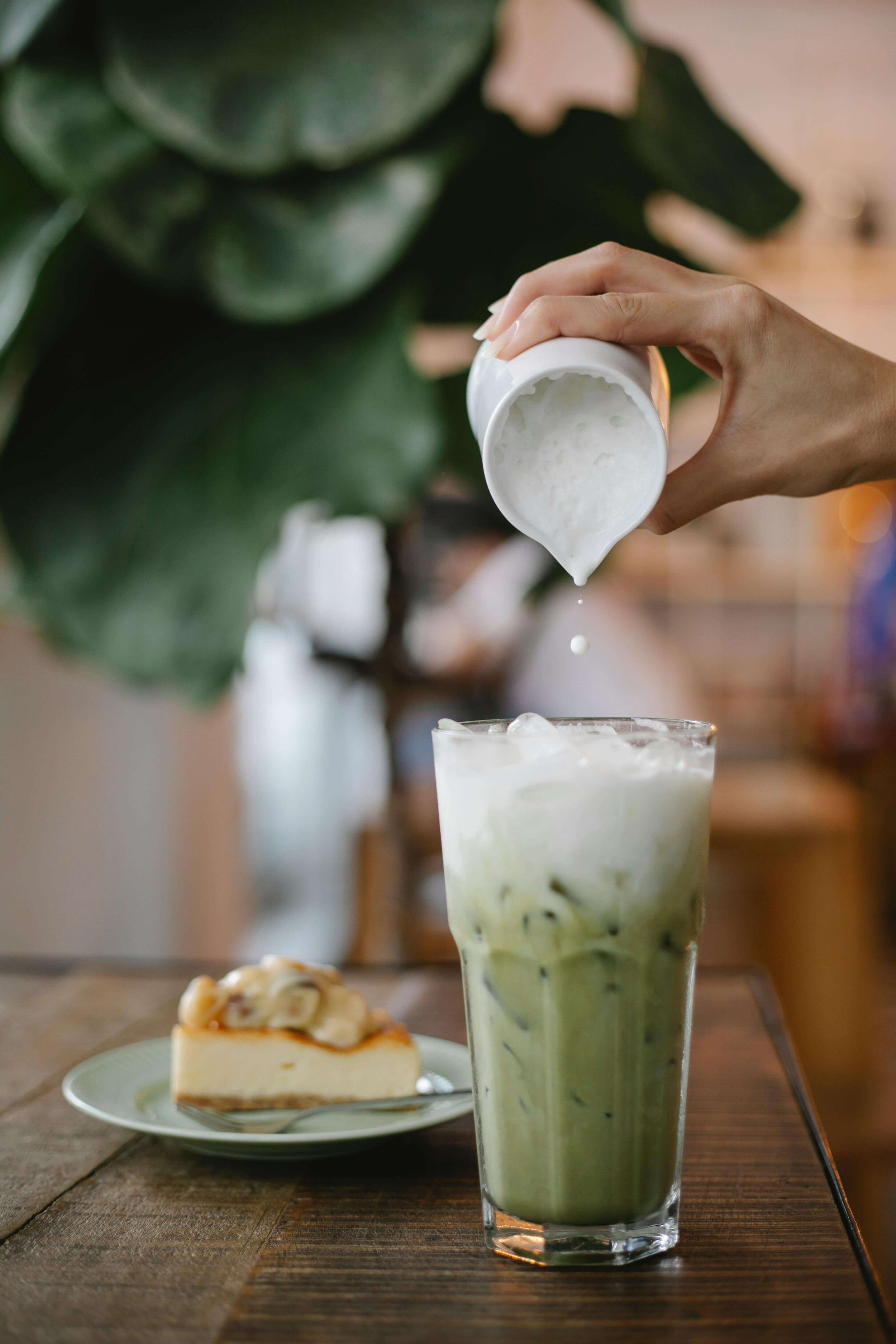 A matcha latte in a clear glass