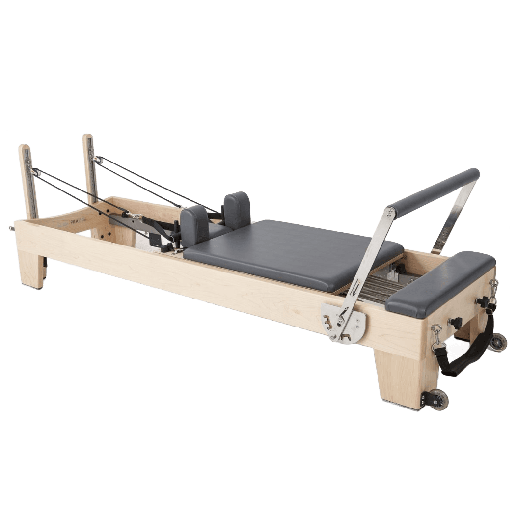 Light wood Pilates reformer with gray padding and straps.