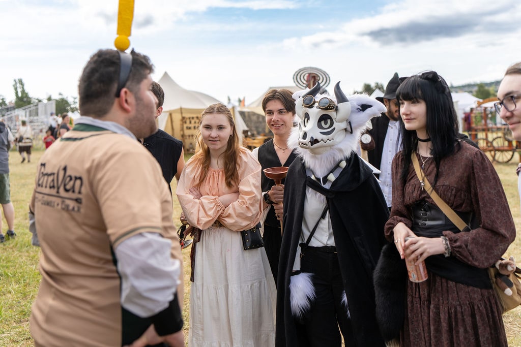 Volunteer with Info icon headband chatting to group of WRF guests
