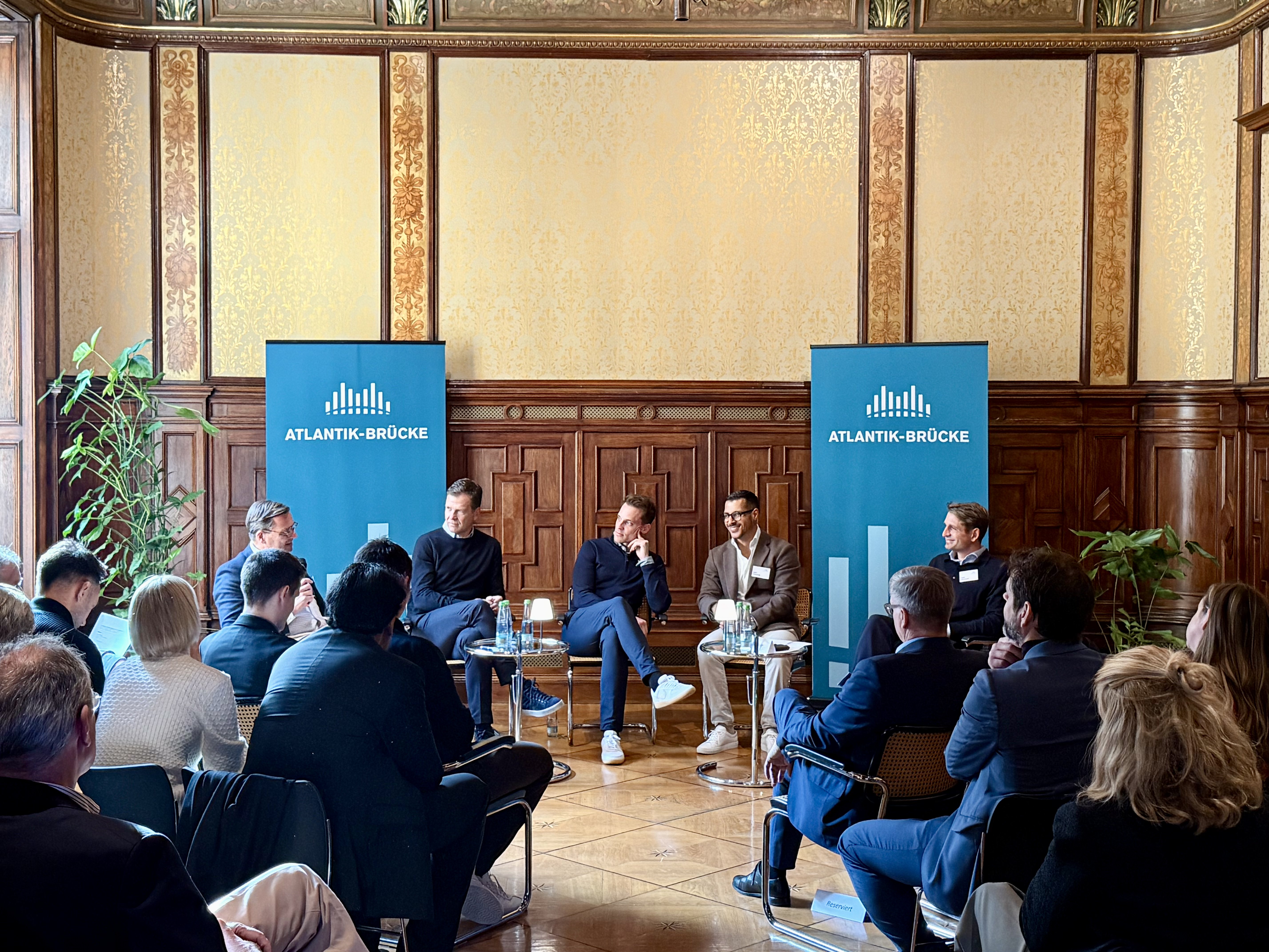 Aerial view of a winding road surrounded by dense green and yellow trees, showcasing nature’s vibrant colors.
