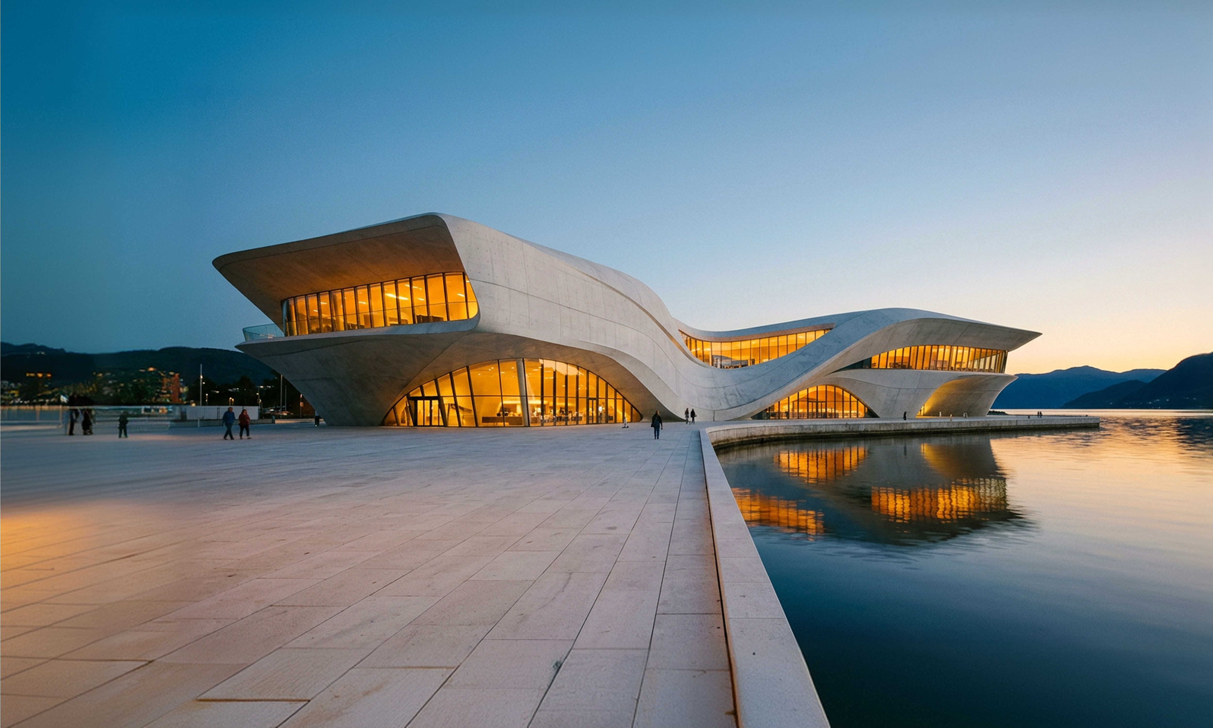 Exterior of Oslo Cultural Centre at dusk, a sweeping Zaha Hadid-inspired concrete structure along the Oslo waterfront