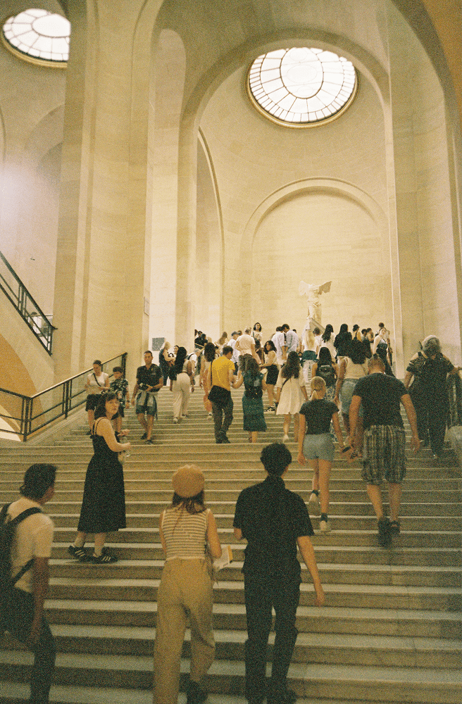 people walking up and down the stairs inside the metropolitan museum of art