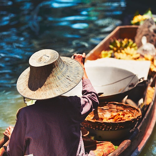 Local farmers selling fruits on a paddle boat