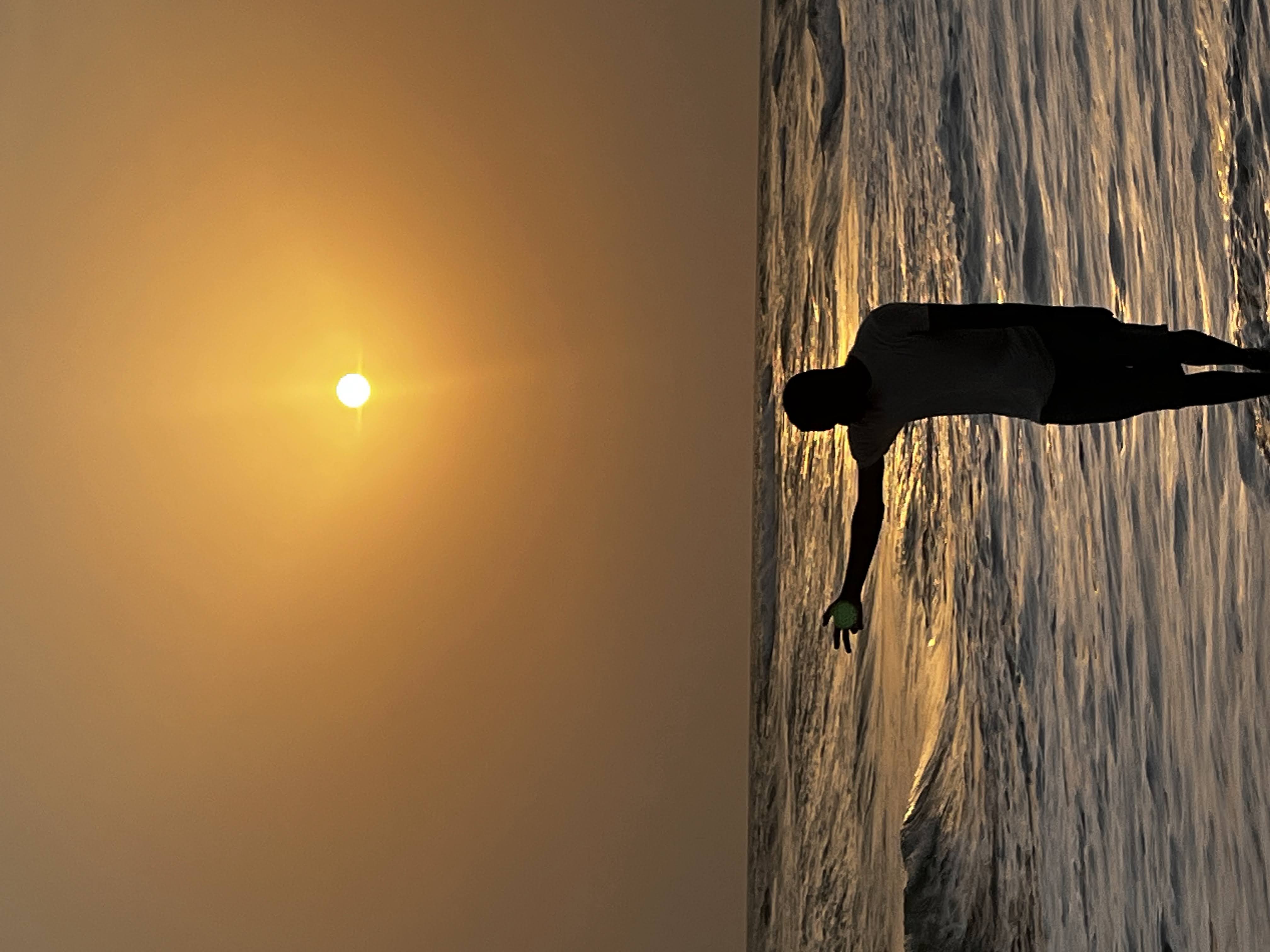 A close-up of a person wearing green-tinted glasses, with a serious expression and smooth skin.