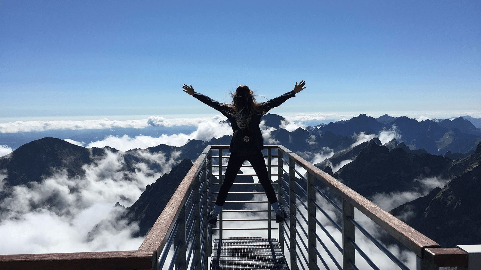 Woman on top of a mountain