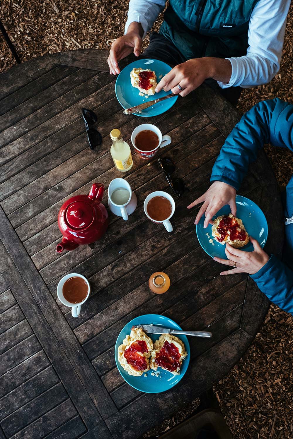 Birds eye image of a table with teas, coffee and cake laid out