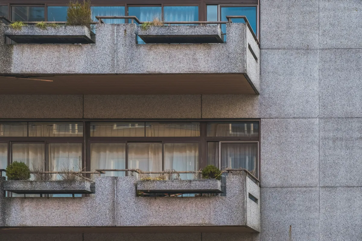 Cour du Rhône — concrete facade at dusk